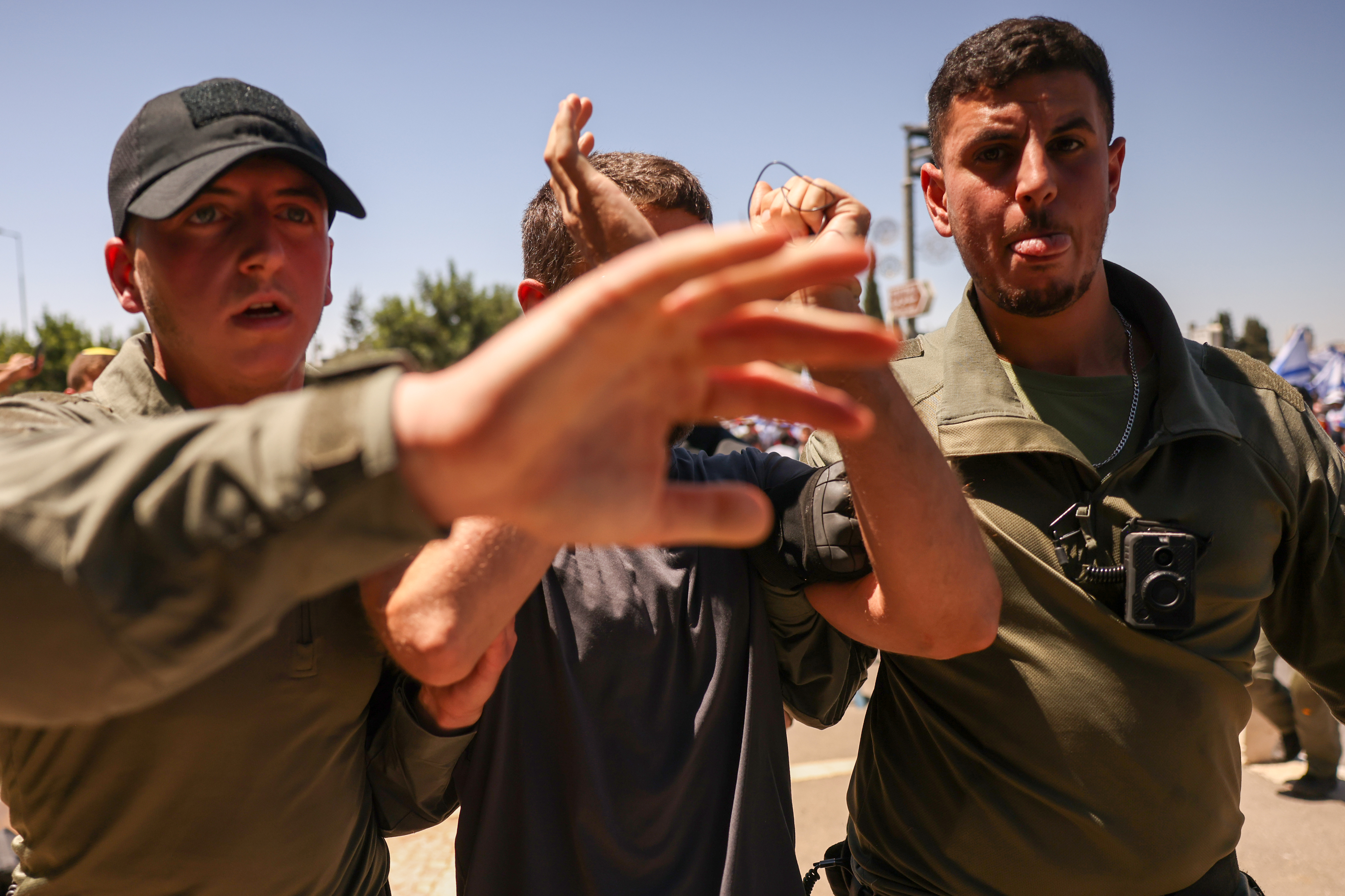 A demonstrator is removed by members of Israel's security forces