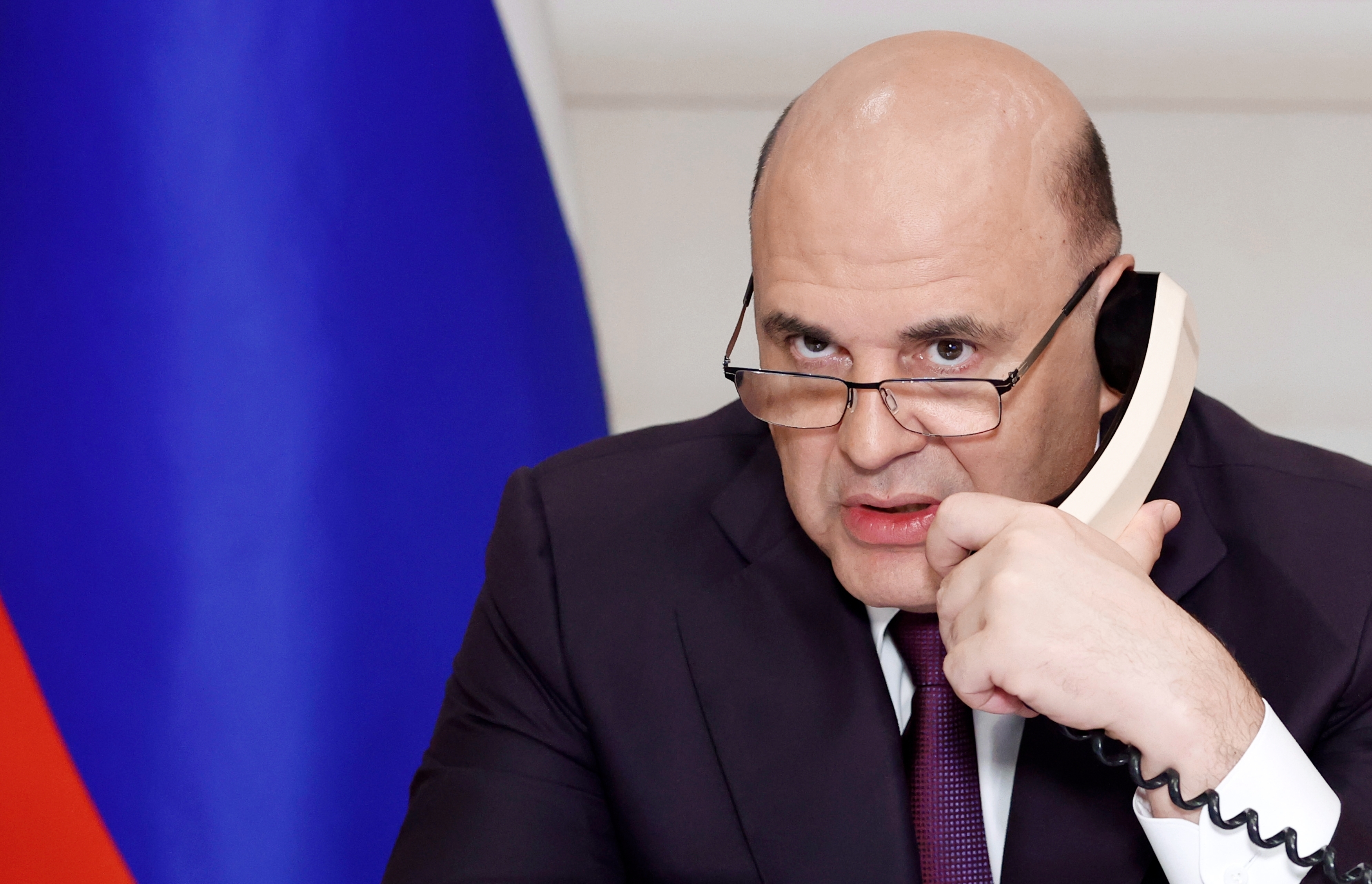 Russian Prime Minister Mikhail Mishustin attends a meeting on metals industries chaired by Russian President Vladimir Putin via video conference in Moscow, Russia, Monday, Aug. 1, 2022. (Dmitry Astakhov, Sputnik, Government Pool Photo via AP)