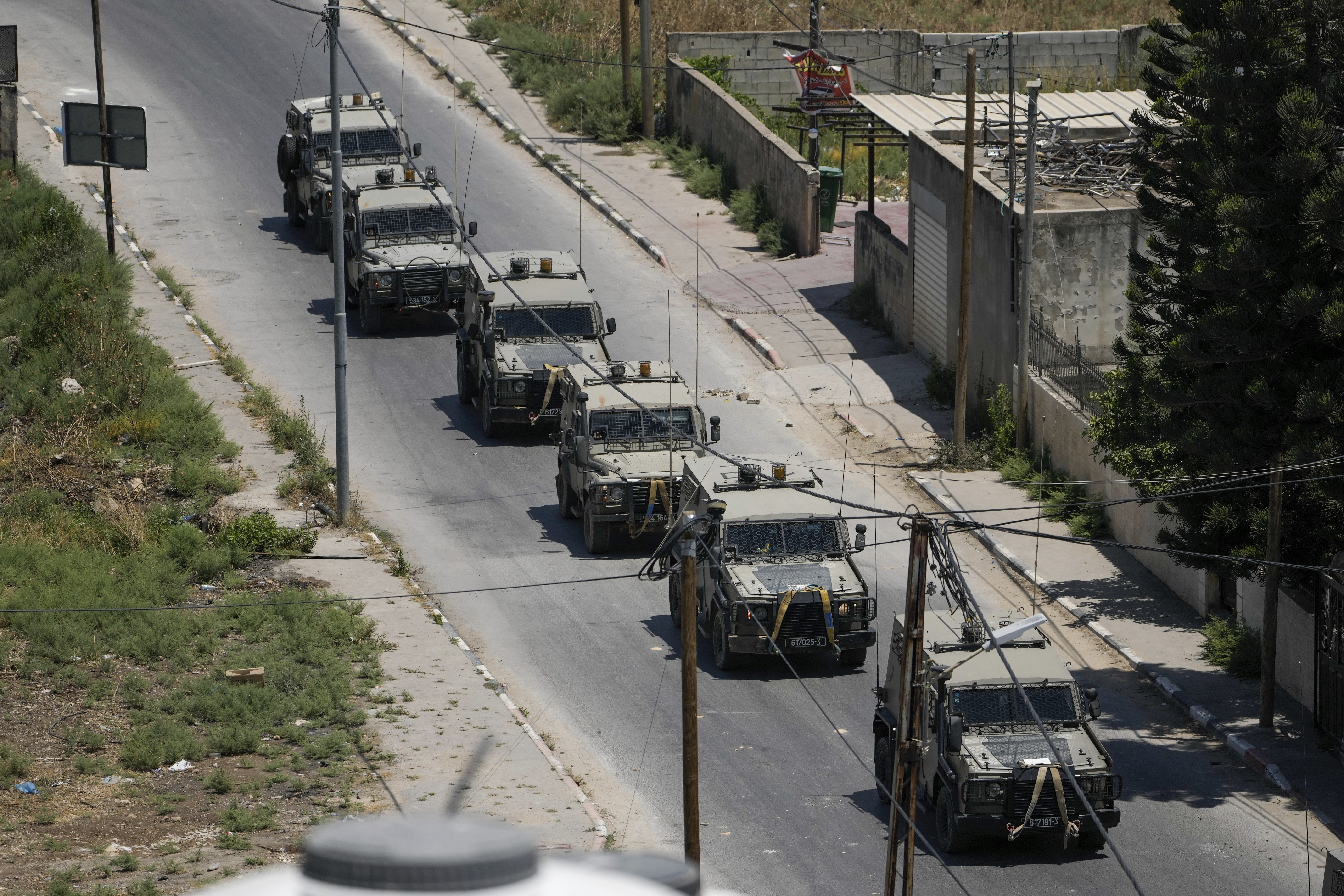 A convoy of army vehicles is seen during an Israeli military raid on the Jenin refugee camp