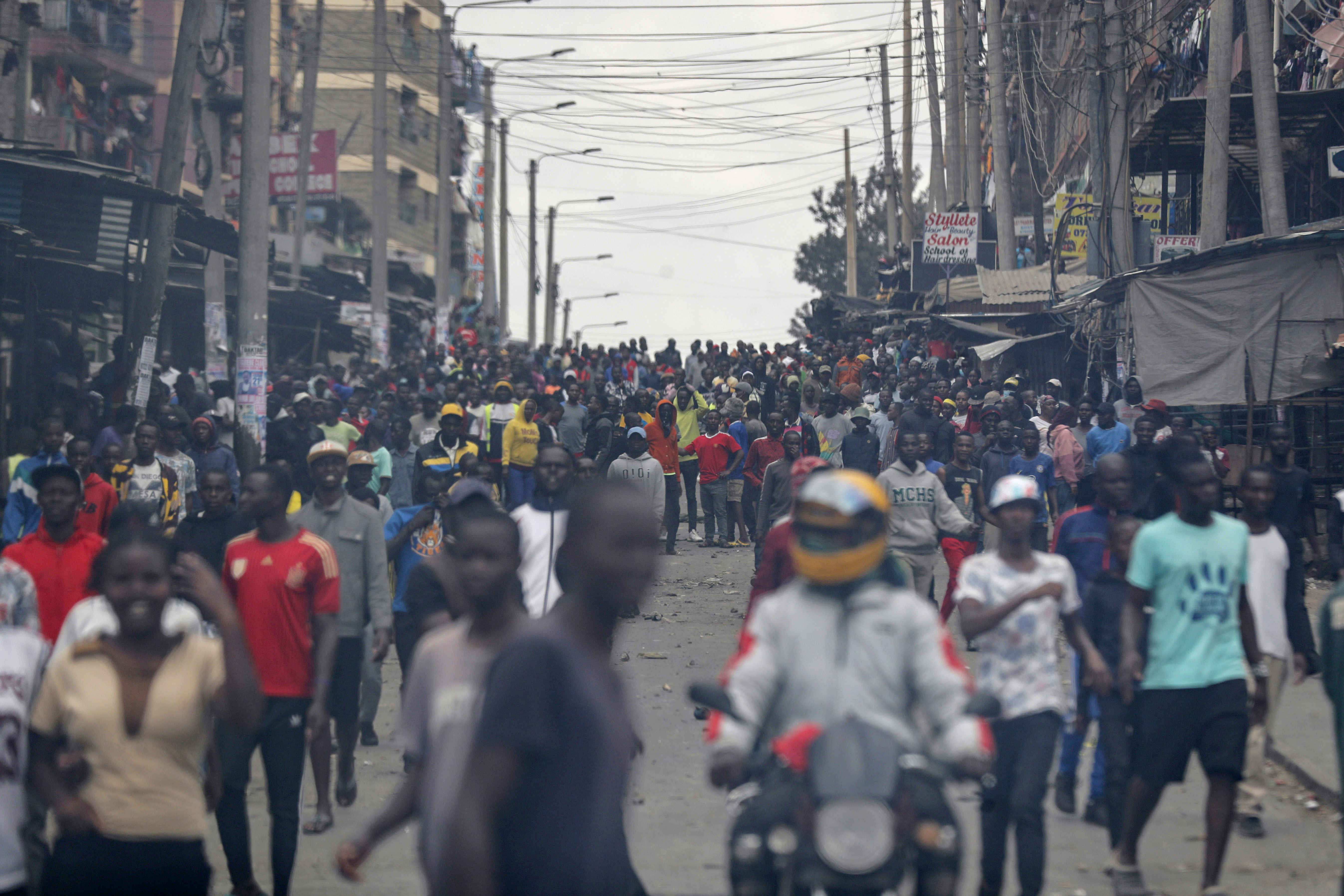 Protesters stand on the road during clashes in the Mathare area of Nairobi,