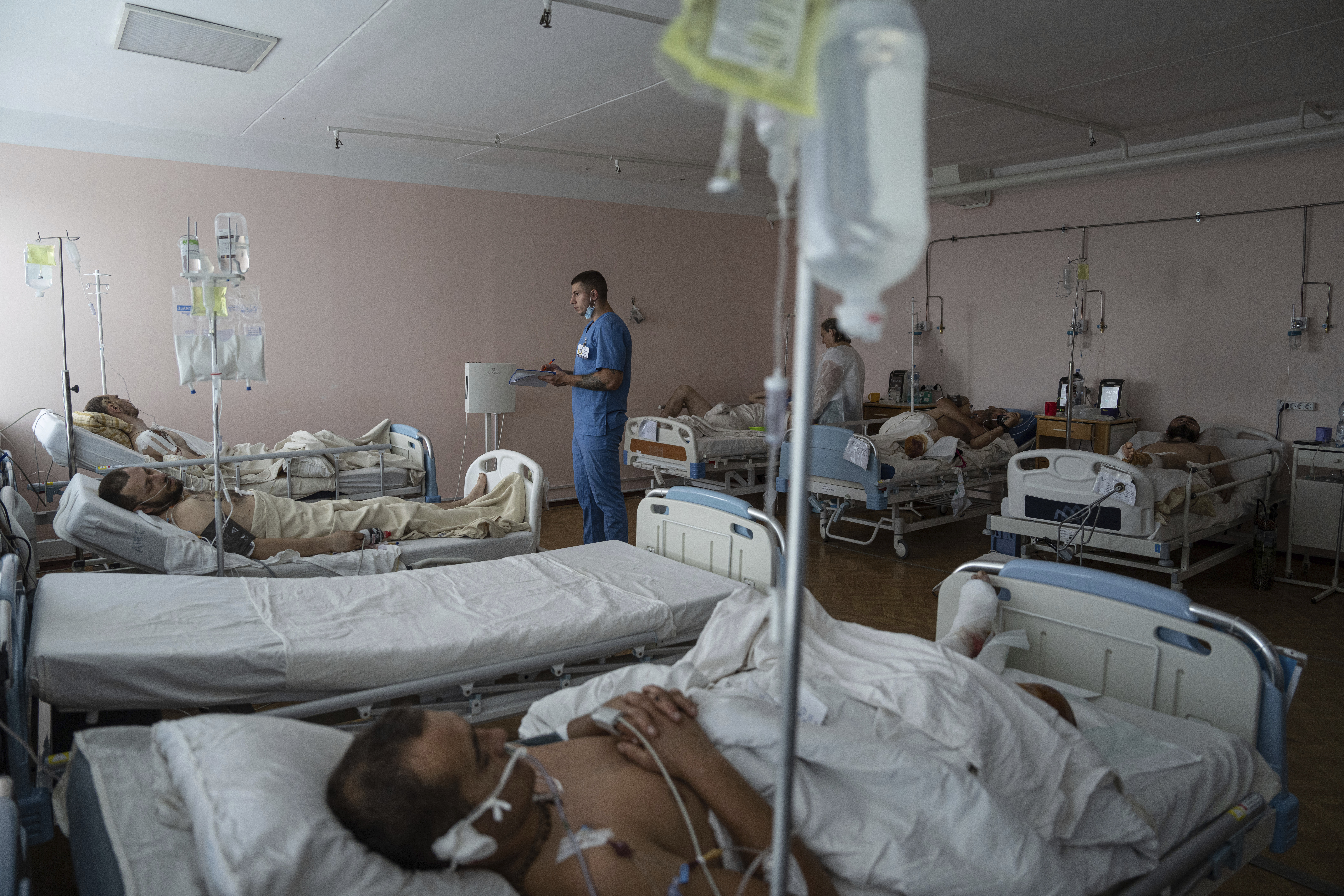 A doctor writes notes inside the ICU of Mechnikov Hospital