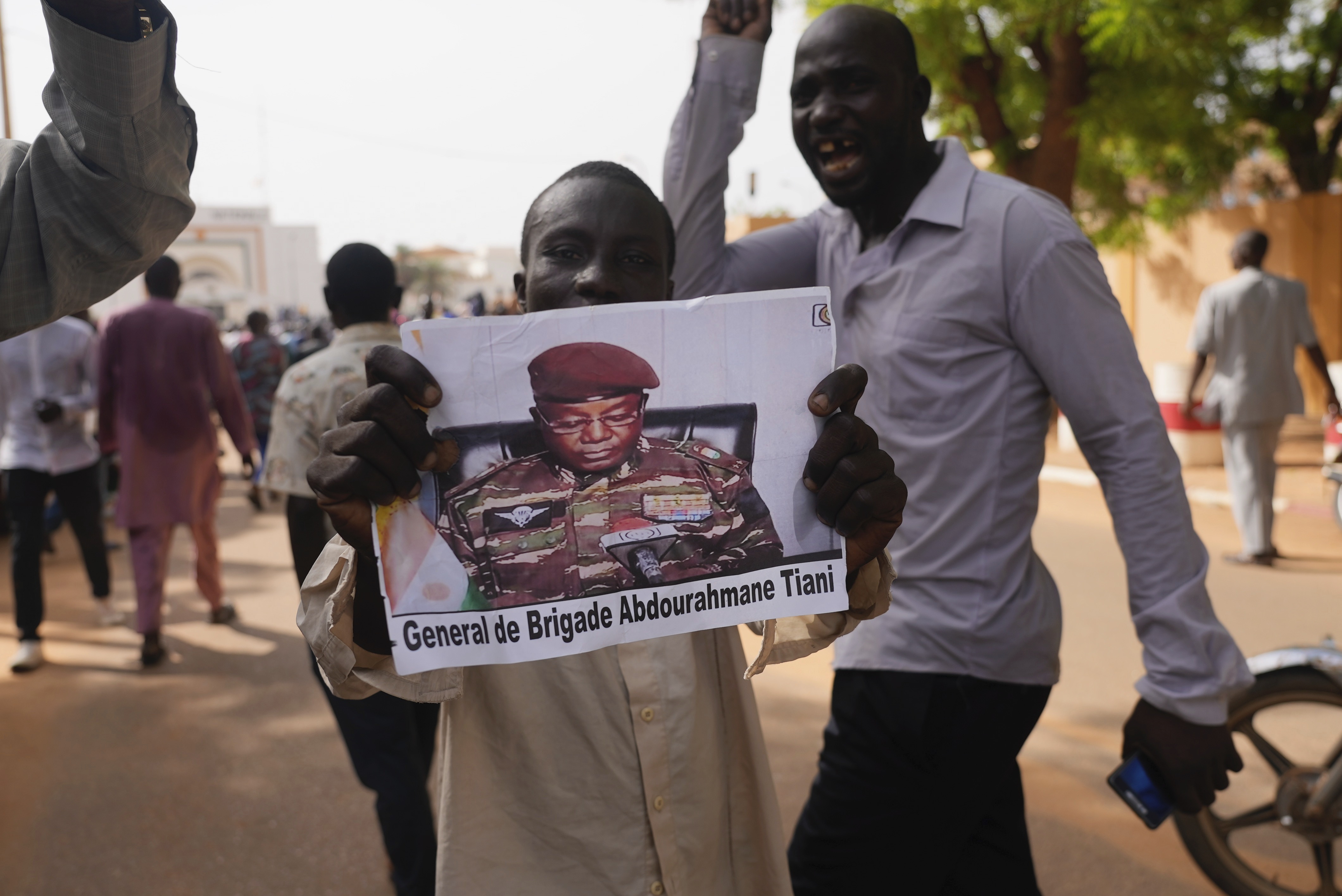 Nigeriens participate in a march called by supporters of coup leader Gen. Abdourahmane Tchiani, pictured, in Niamey, Niger, Sunday, July 30, 2023. Days after after mutinous soldiers ousted Niger's democratically elected president, uncertainty is mounting about the country's future and some are calling out the junta's reasons for seizing control