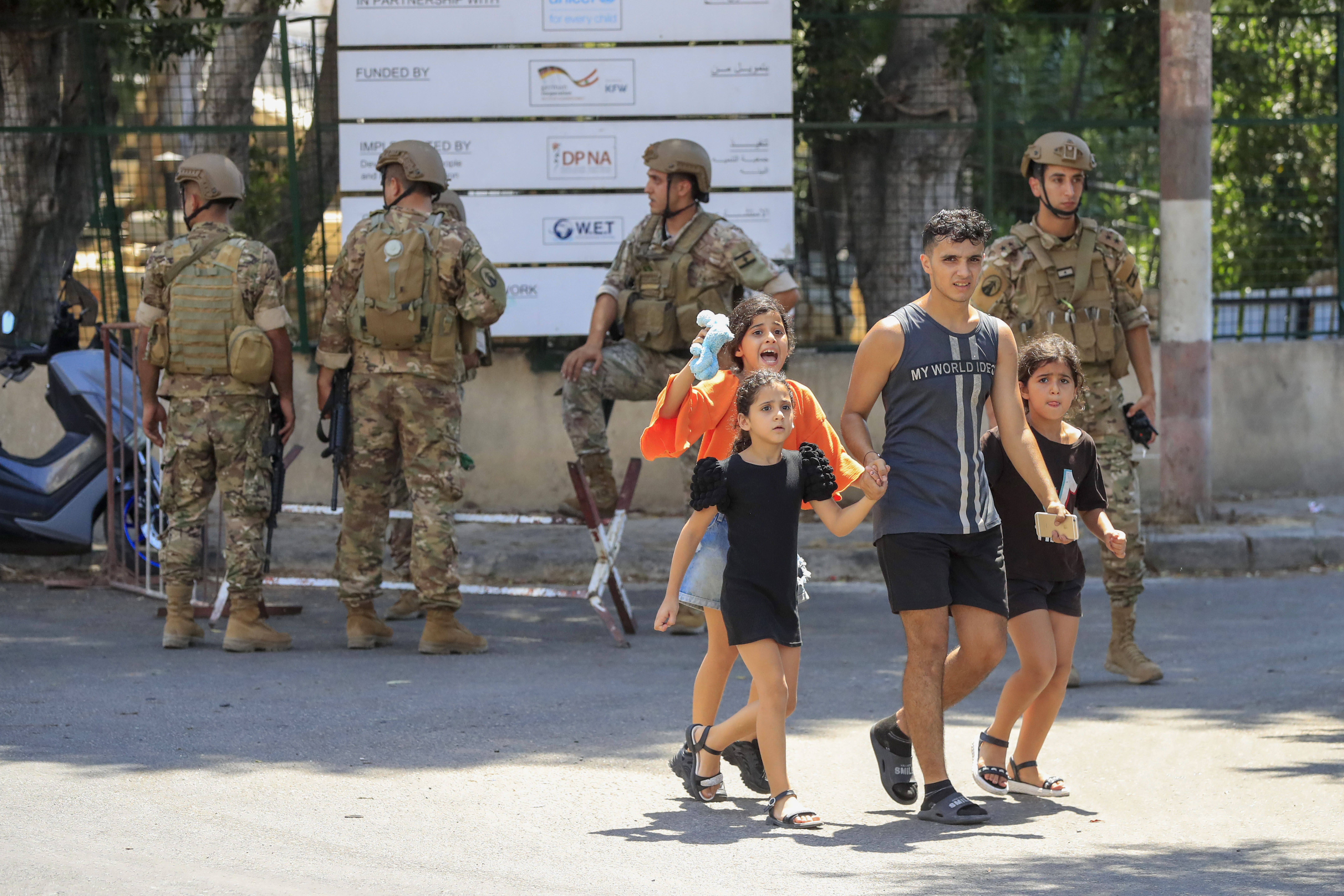 Palestinian residents flee their home in the refugee camp of Ein el-Hilweh near the southern port city of Sidon, Lebanon