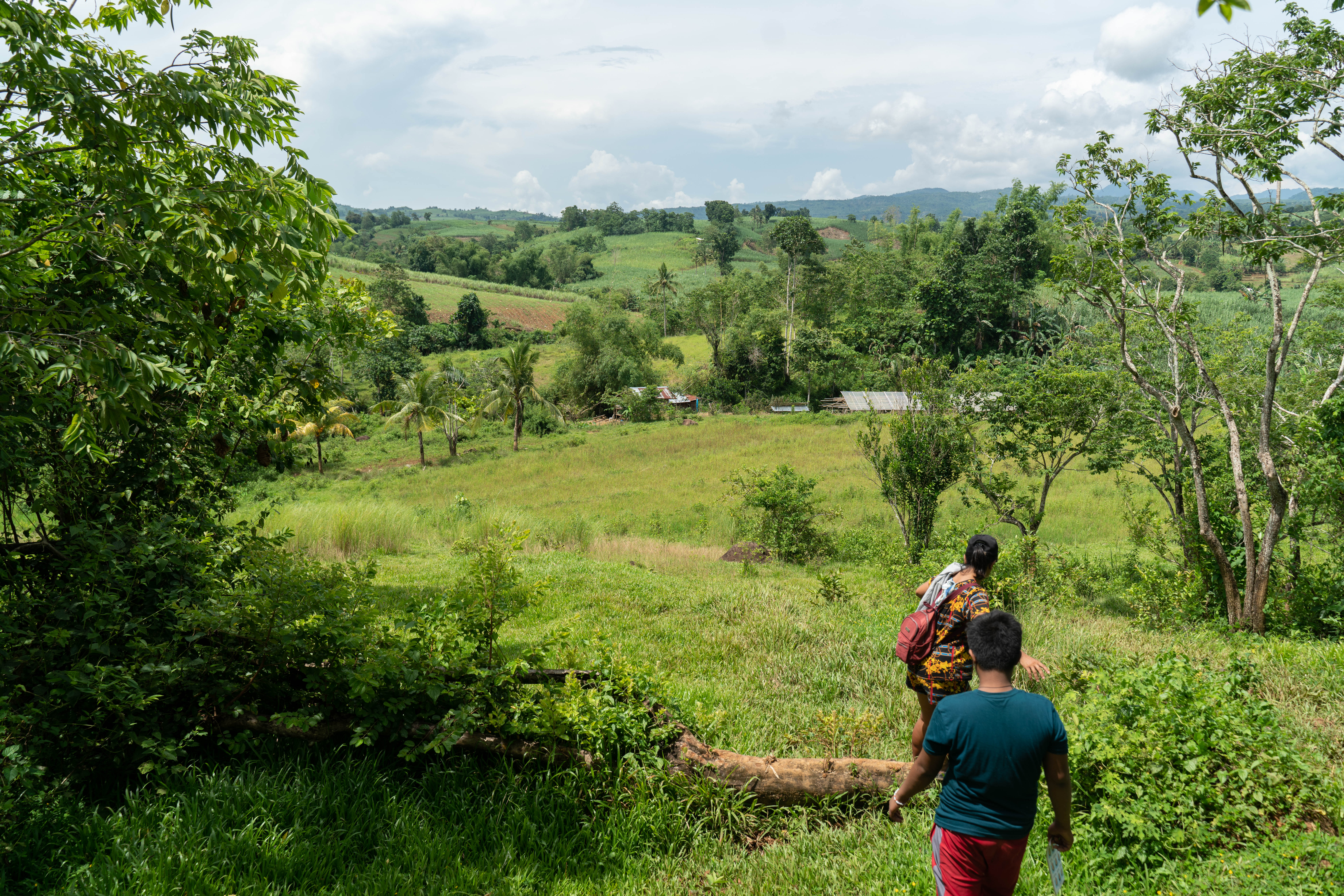Villagers walking down a hill in Negros. Crispin's son said soldiers fired at him from this spot. 