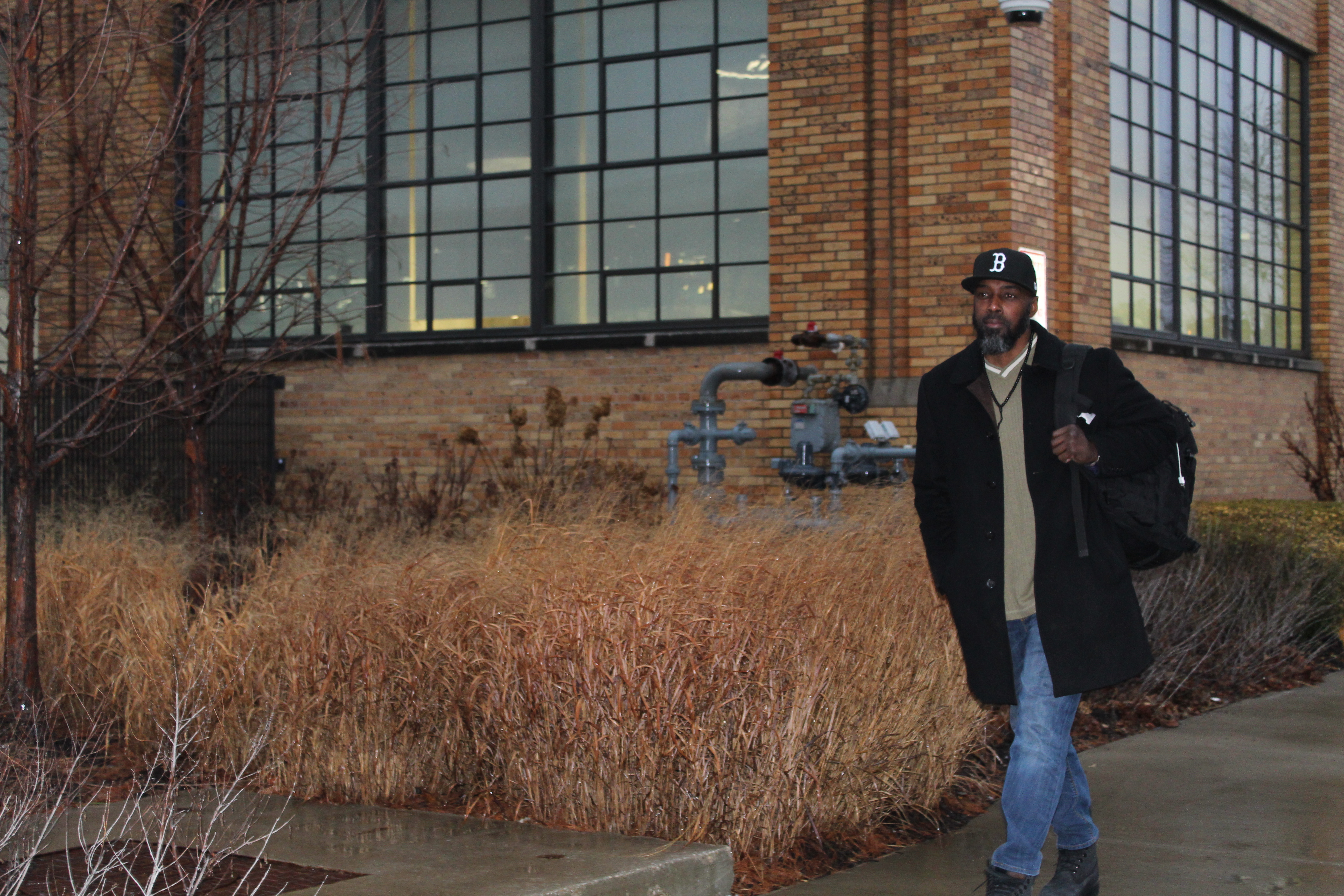 A photo of Ronni Amiin walking out of a building.