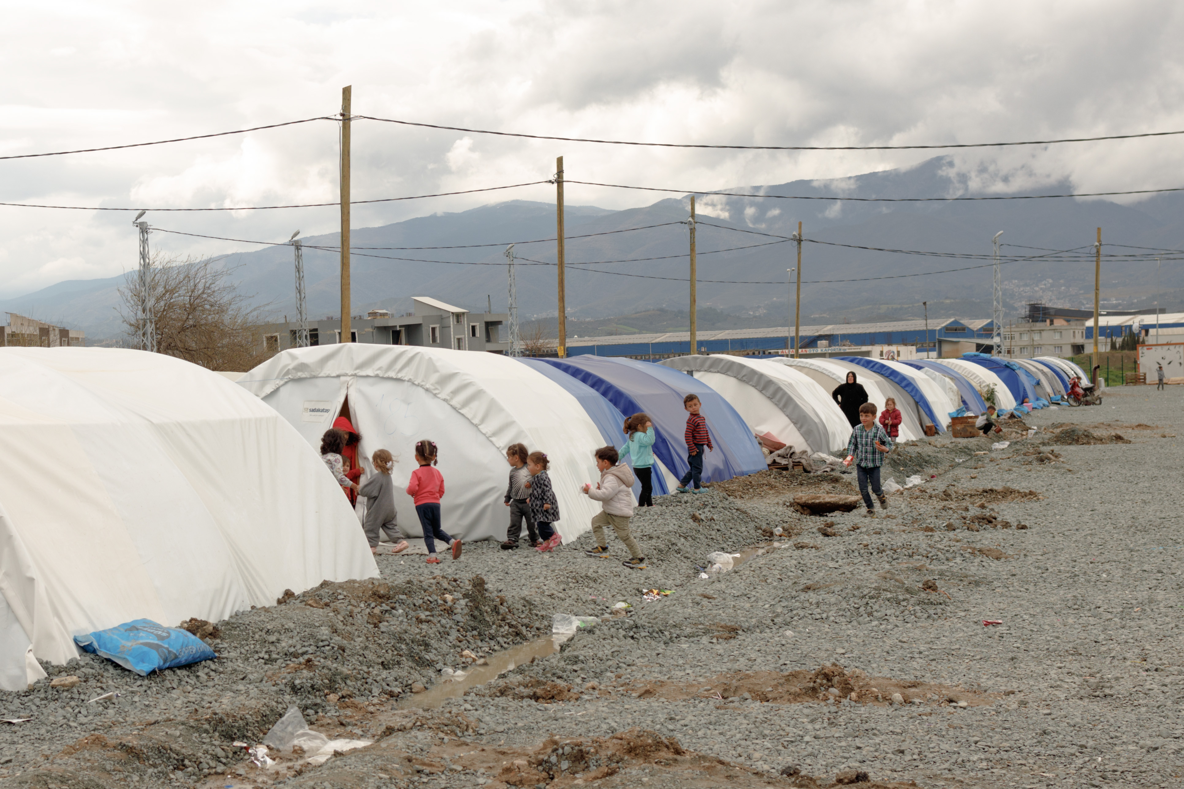 Children run and play inside a camp set up in Antakya, Hatay