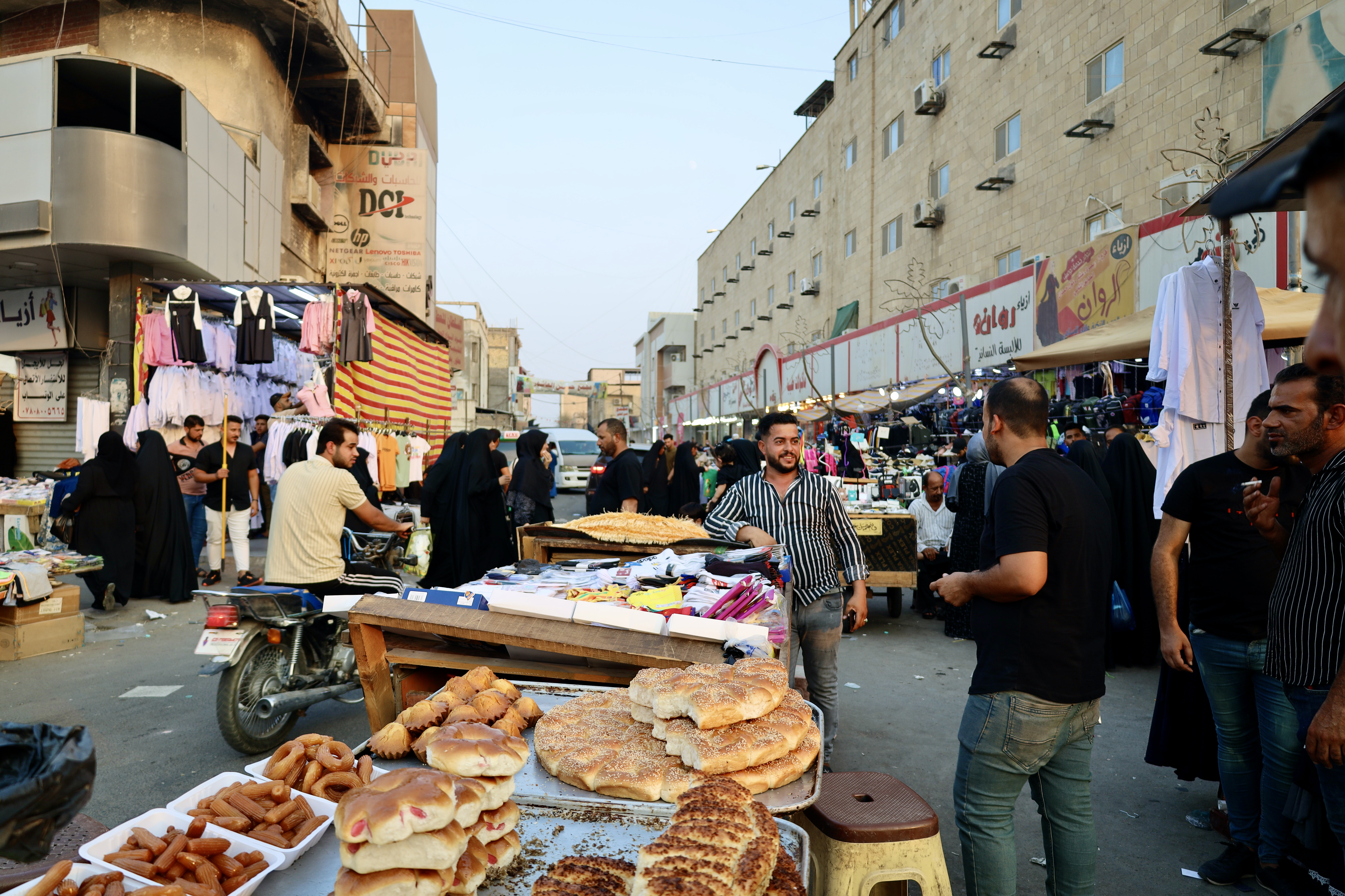 People are seen in the street during nearly unbearable temperatures in Basra, Iraq