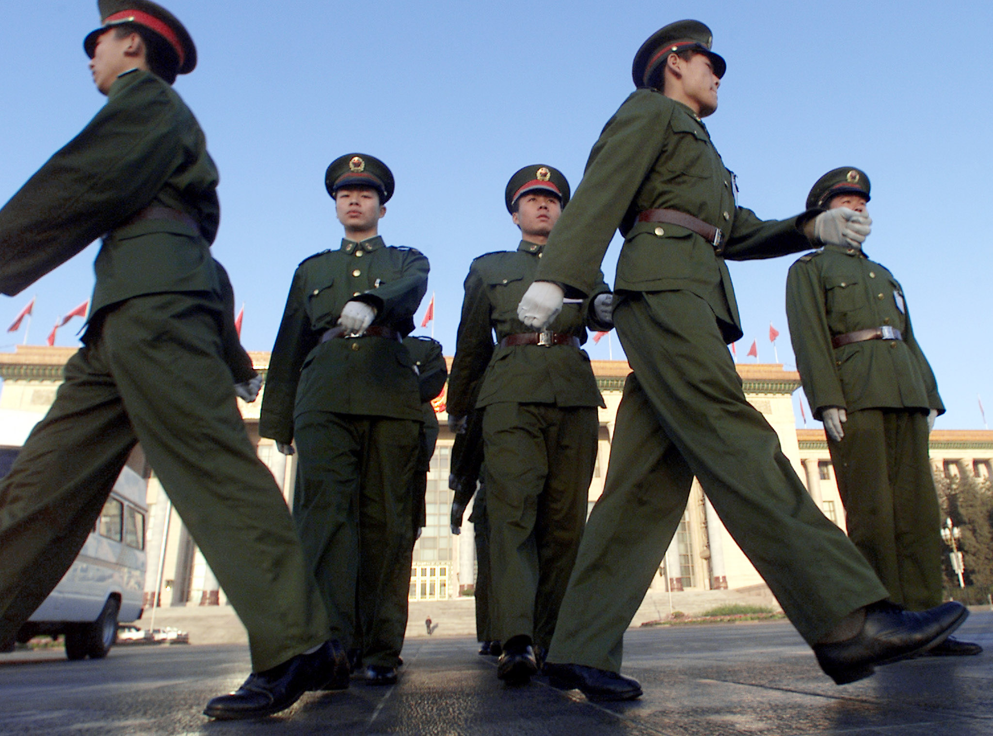 Chinese soldiers patrol the Great Hall of the People before the annual session of the National People's Congress (NPC), or parliament, in Beijing March 11, 2002. [The NPC delegates listened to reports on the work of the Supreme People's Court and the Supreme People's Procuratorate. The Supreme People's Procuratorate investigated 36,447 corruption cases involving 40,195 people and more than 4.1 billion yuan ($495.8 million).]