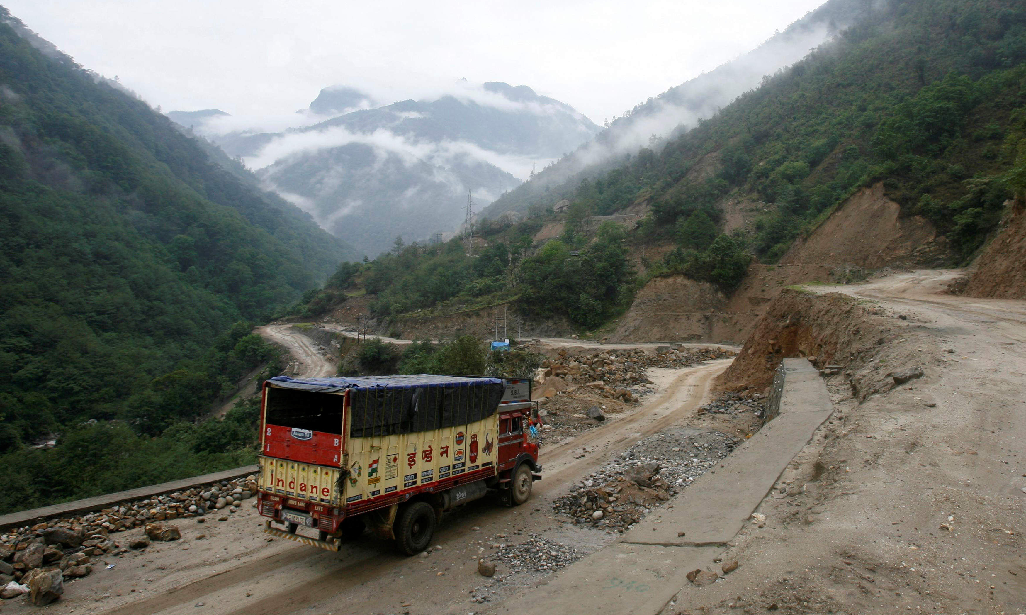 A liquefied petroleum gas (LPG) delivery truck drives along India's Tezpur-Tawang highway which runs to the Chinese border, in the northeastern Indian state of Arunachal Pradesh May 29, 2012.