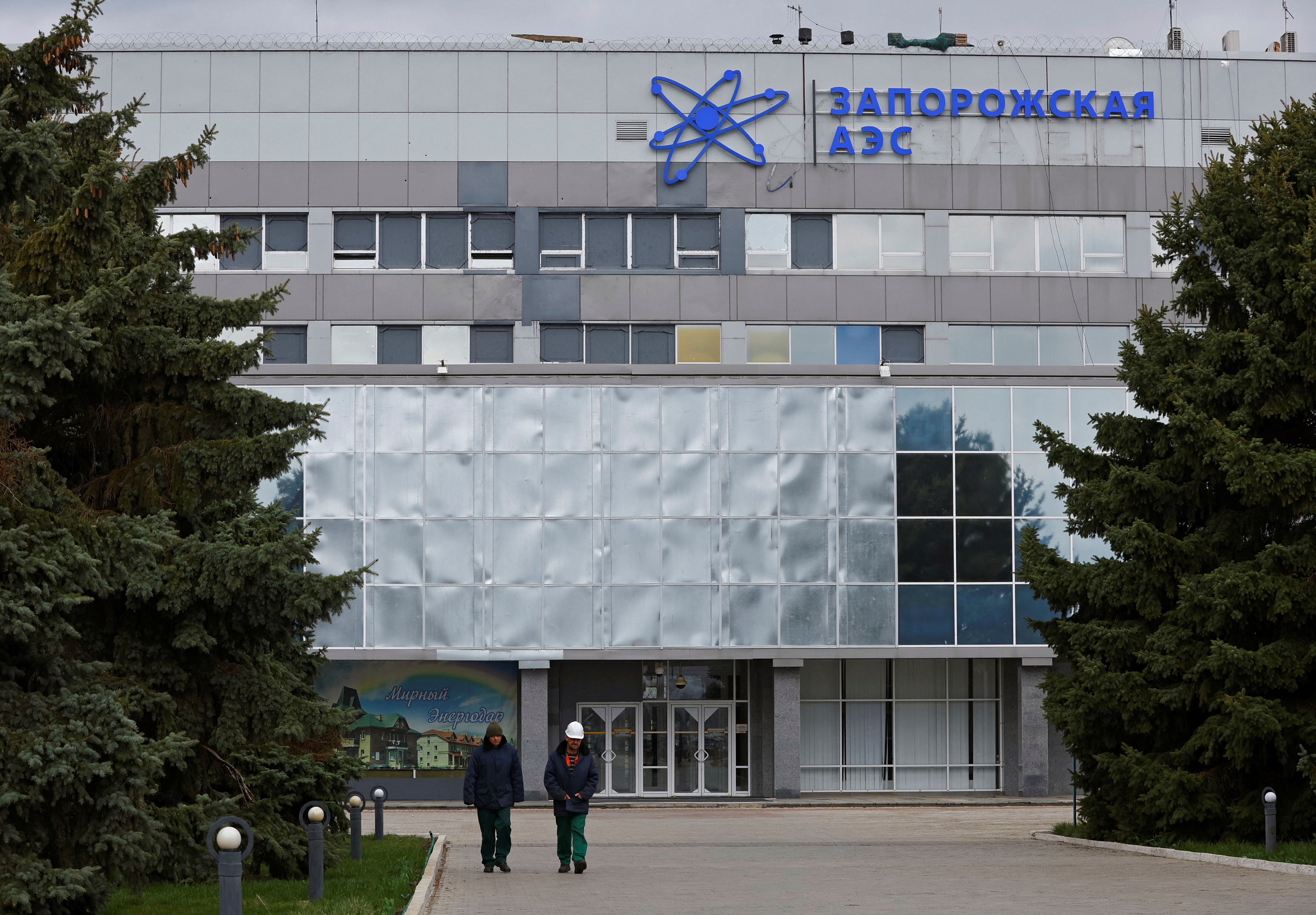 People walk outside the Zaporizhzhia Nuclear Power Plant in the course of Russia-Ukraine conflict outside Enerhodar in the Zaporizhzhia region, Russian-controlled Ukraine, March 29, 2023. REUTERS/Alexander Ermochenko