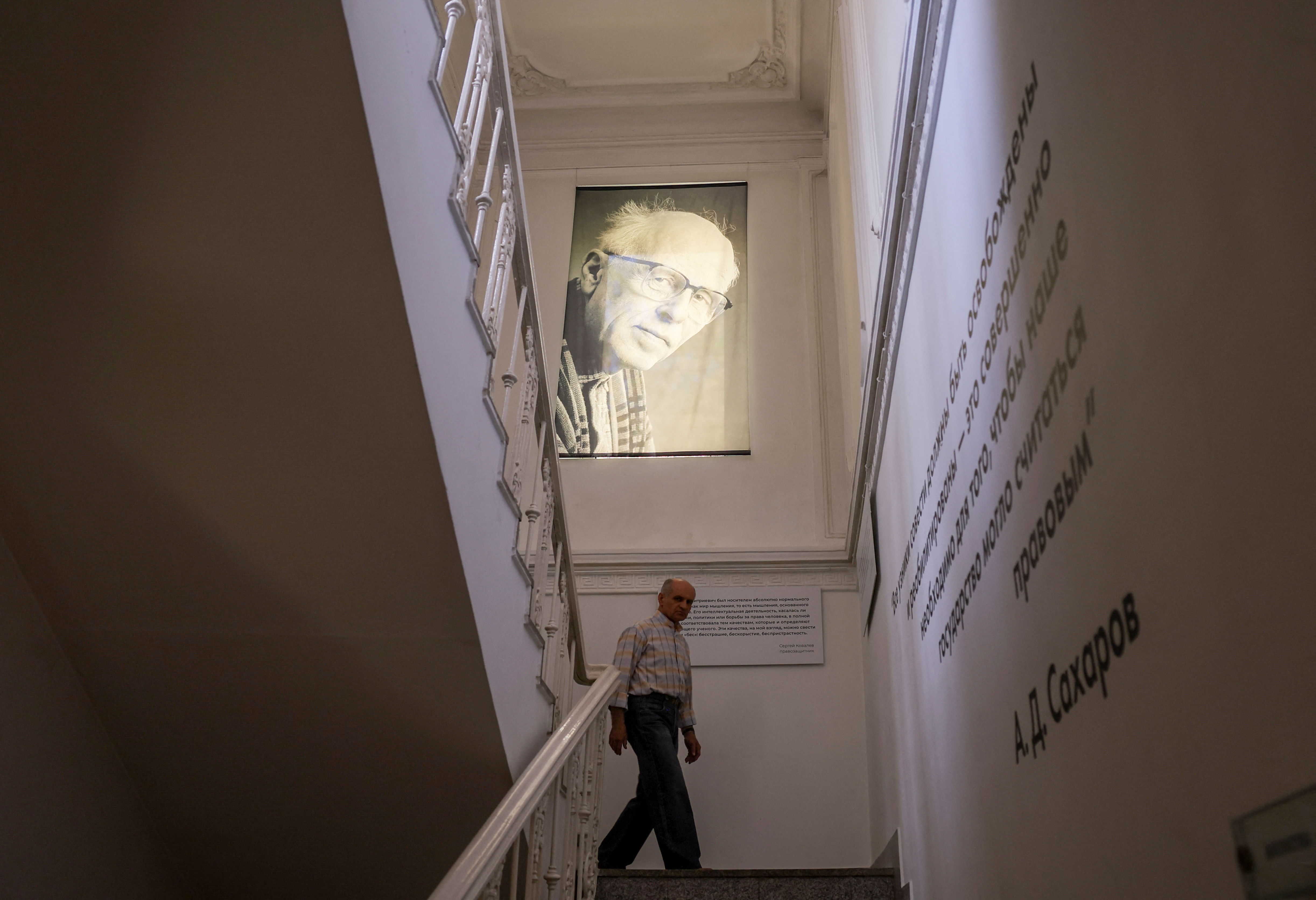 A man walks under a portrait of Nobel laureate and Soviet-era dissident Andrei Sakharov at the Sakharov Centre in Moscow
