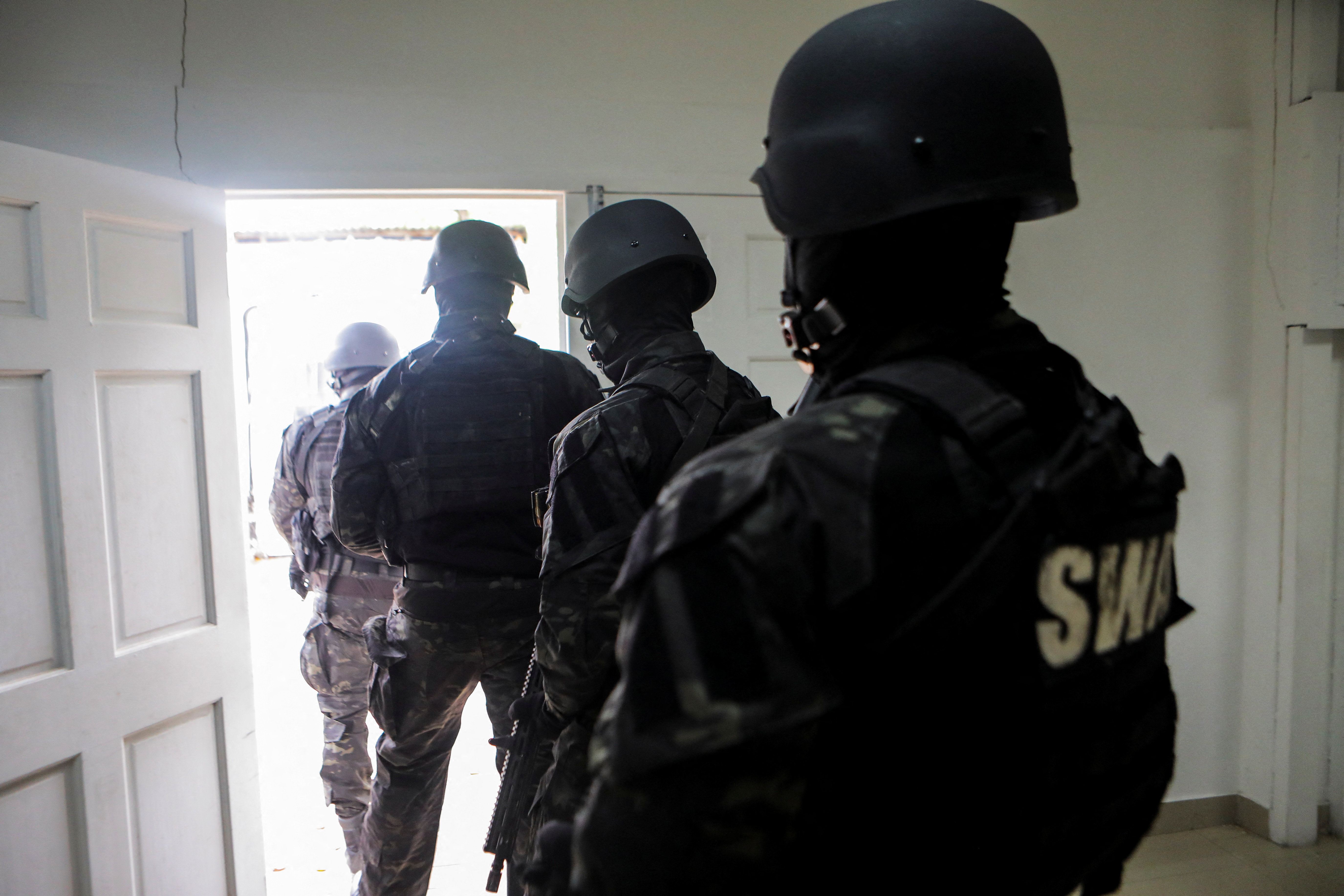 Members of the Haitian national police force leave a news conference