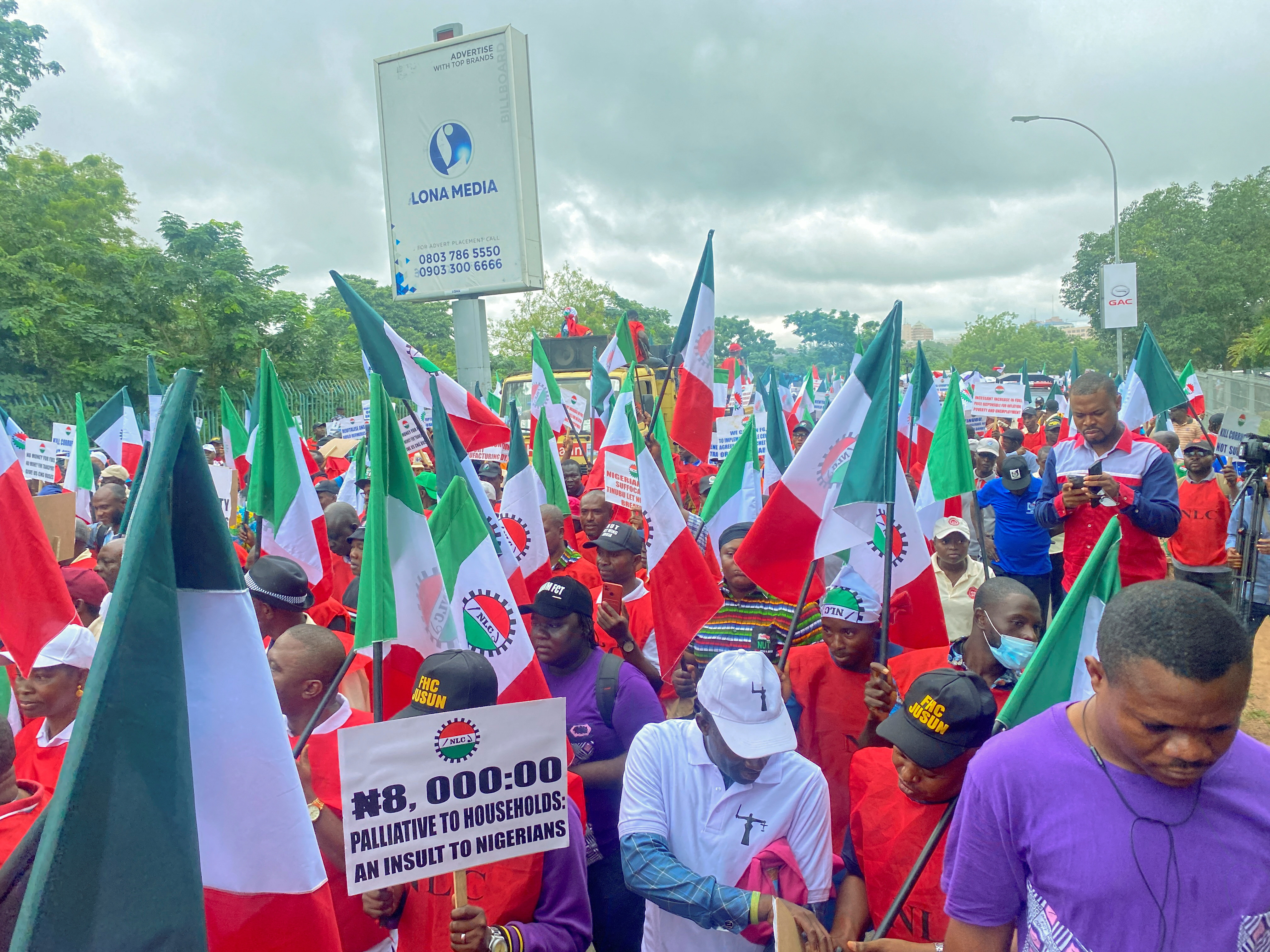 Members of the Nigerian Labour Union, holding flags and placards, march during a protest against fuel price hikes and rising costs, in Abuja, Nigeria August 2, 2023.