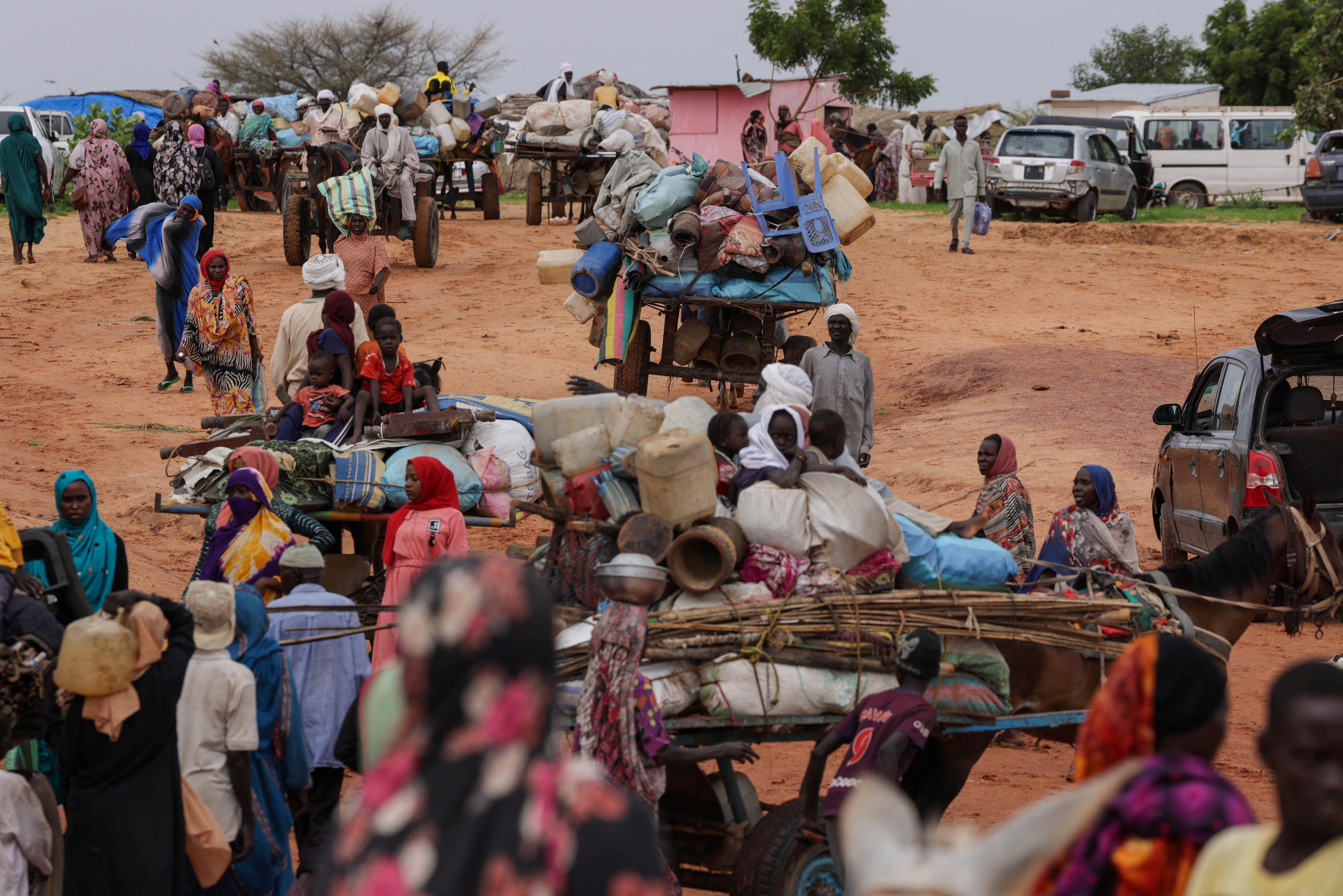 Chadian cart owners transport belongings of Sudanese people who fled the conflict in Sudan's Darfur region, while crossing the border between Sudan and Chad in Adre, Chad August 4, 2023.
