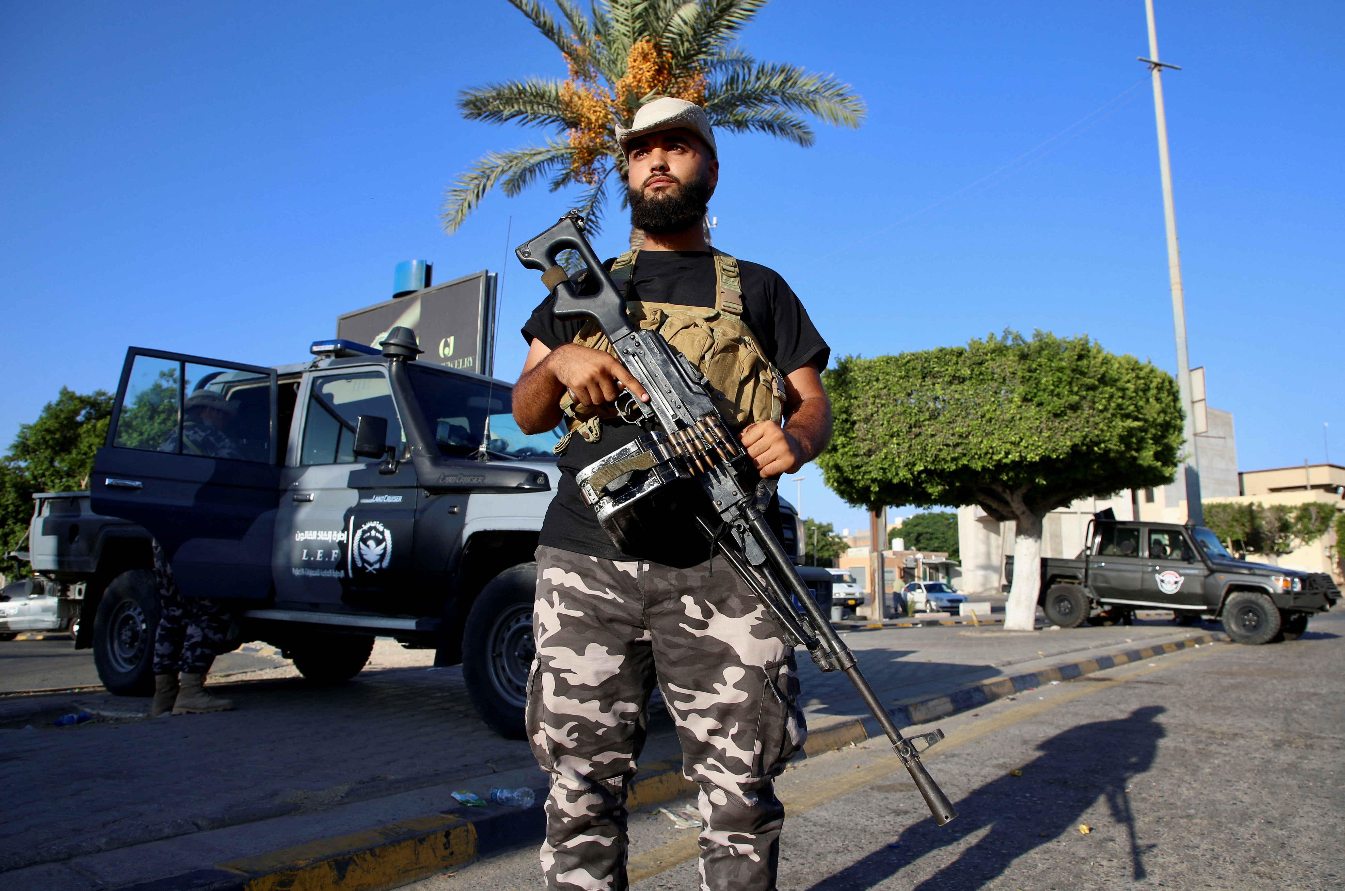 A member of the Security personnel affiliated with the Ministry of Interior secures the street after yesterday's clashes between armed factions in Tripoli, Libya