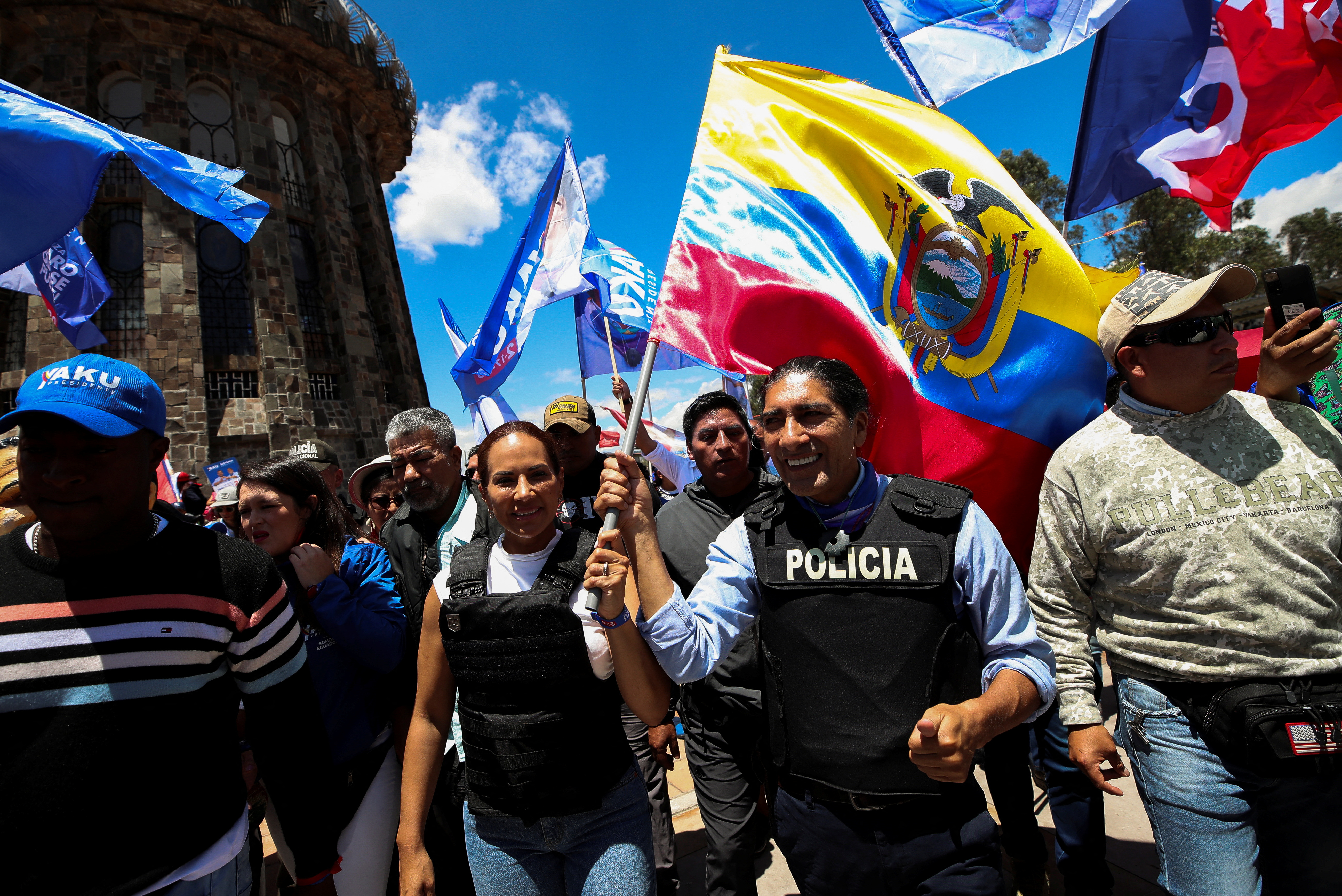 Yaku Perez, surrounded by people, holding an Ecuador flag