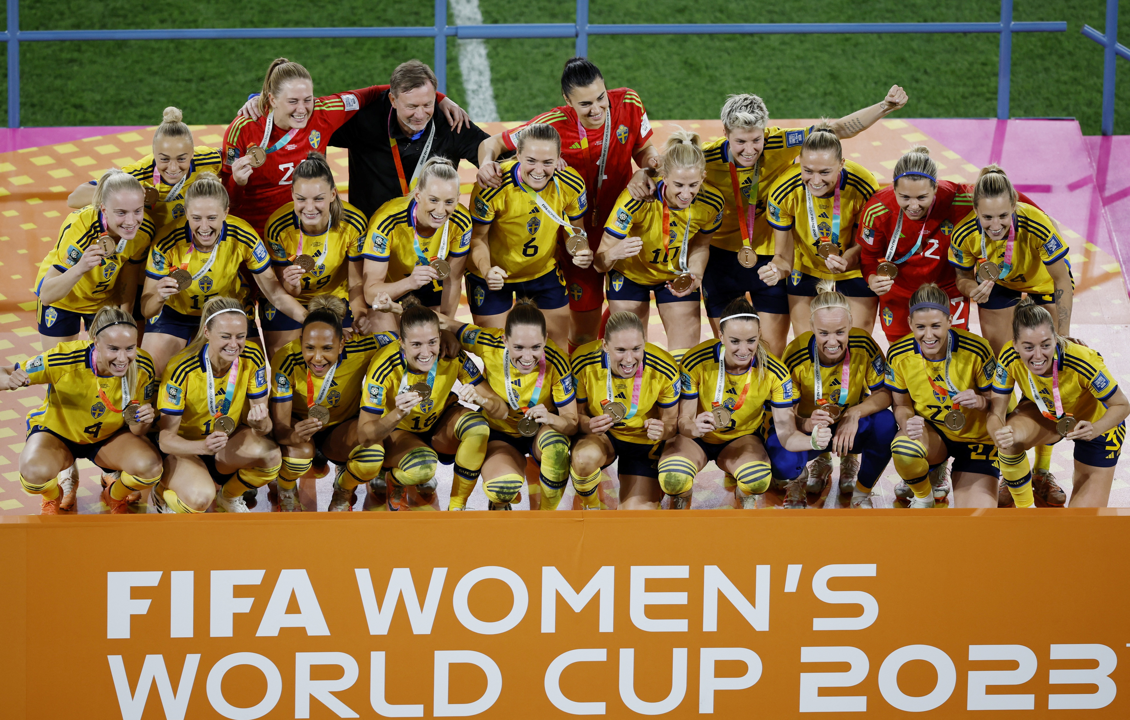 weden pose on the stage after receiving their third place medals