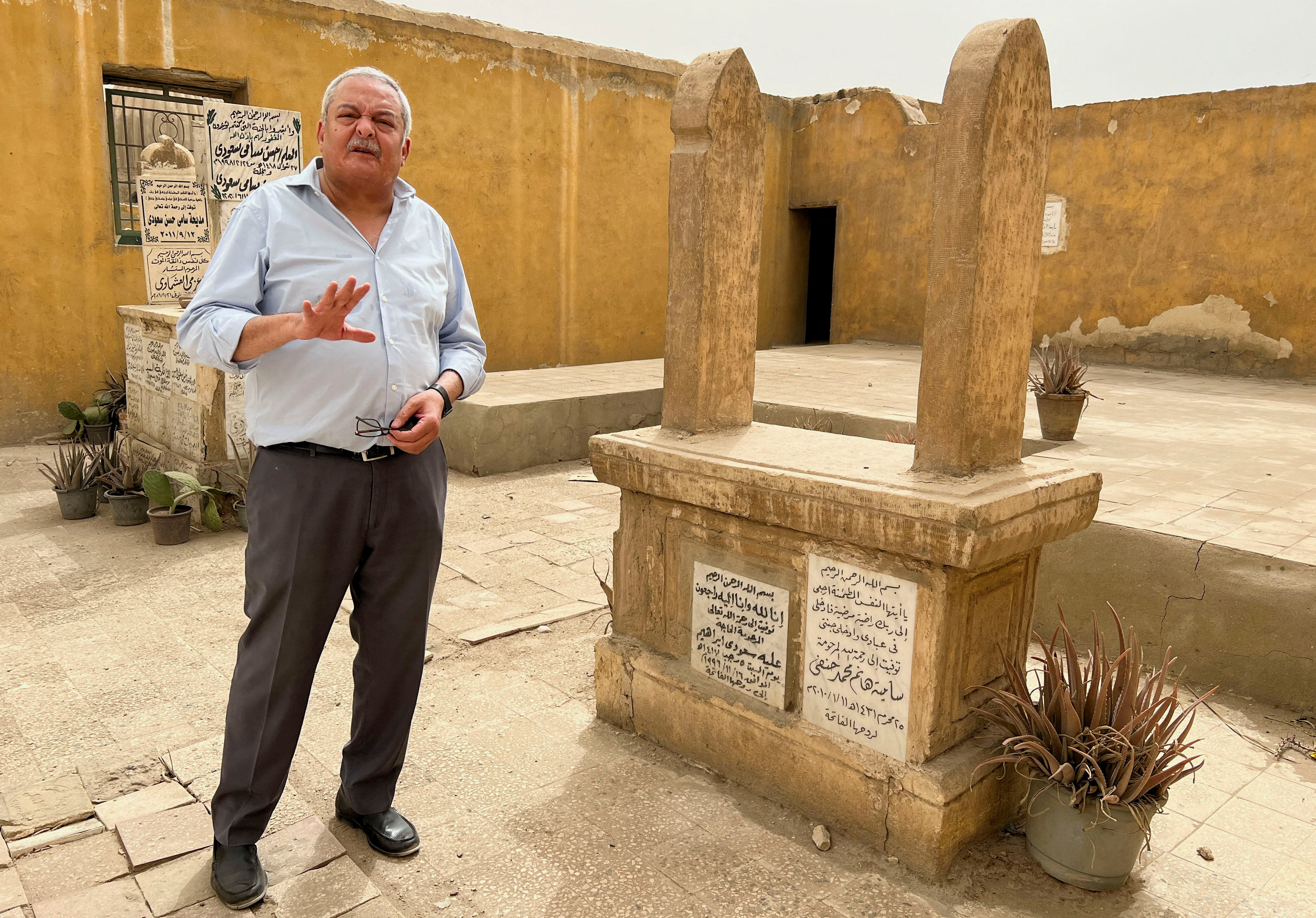 Hisham Kassem, a former newspaper publisher and political activist, speaks during an interview with Reuters TV at his family's cemetery, which is planned to be demolished, across The City of the Dead