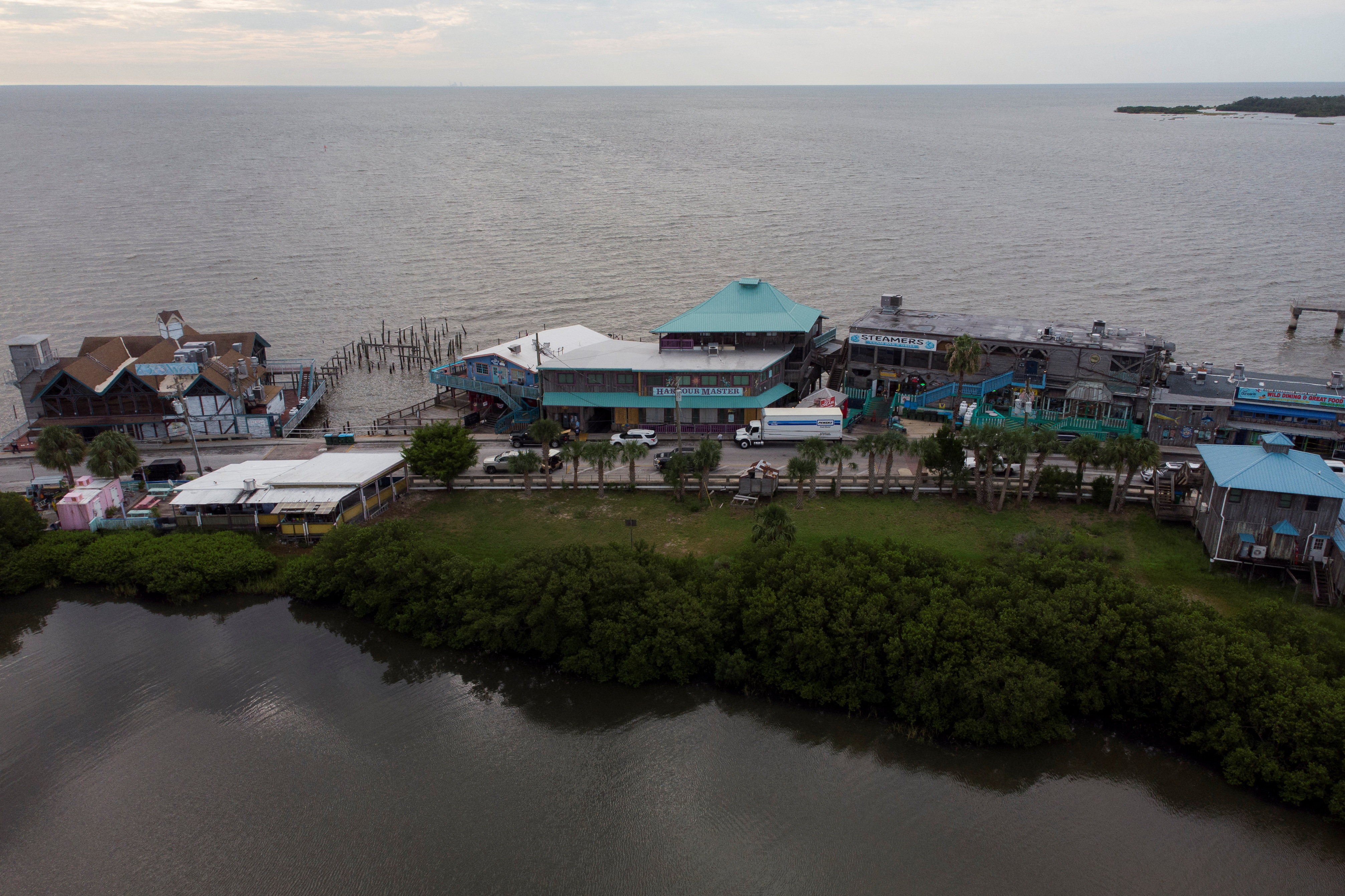 An aerial view of Cedar Key, a barrier island dotted with houses and businesses on the Gulf Coast of Florida.