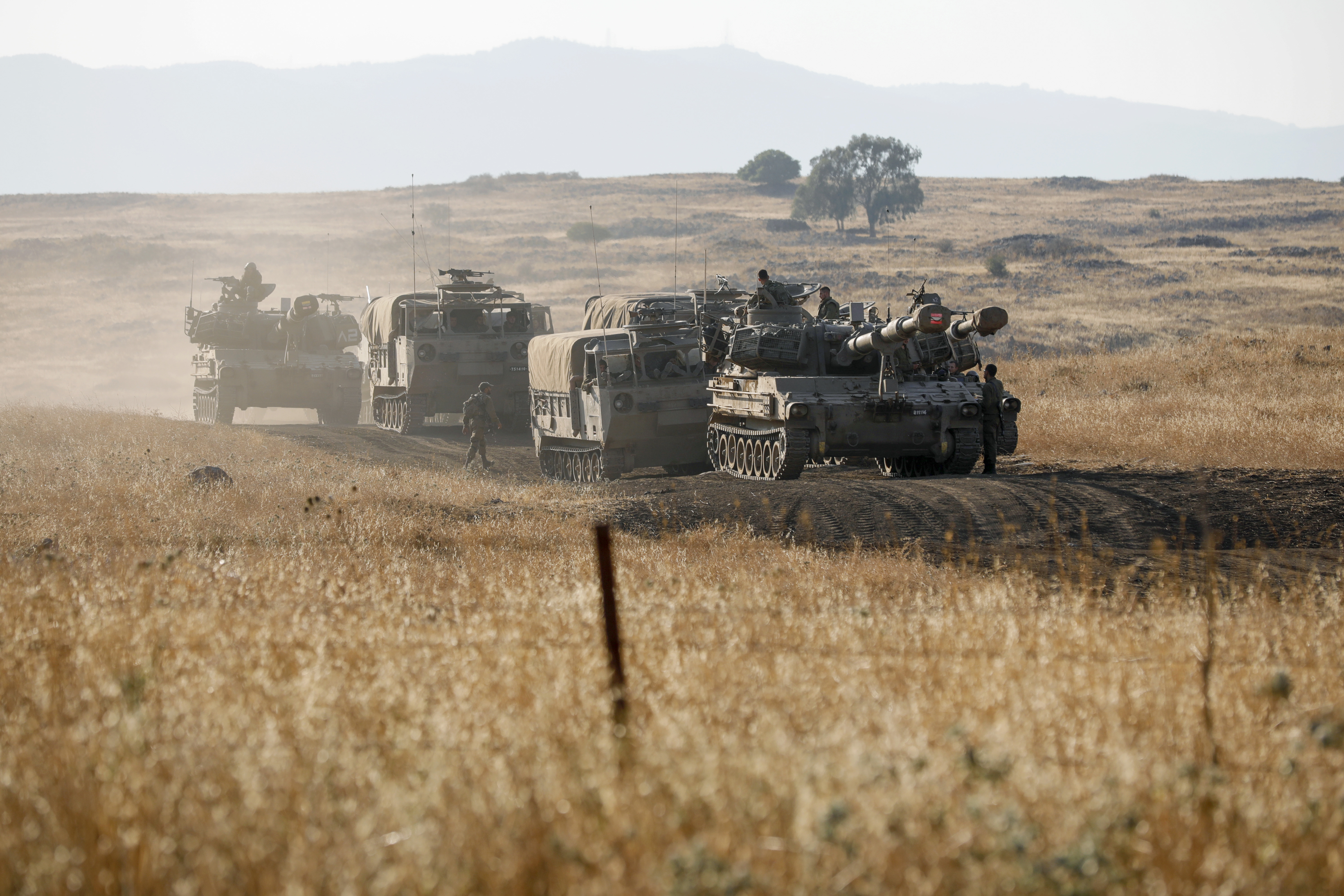 Israeli soldiers reposition military vehicles including self-propelled artillery during a drill in the annexed Golan Heights on July 17, 2023.