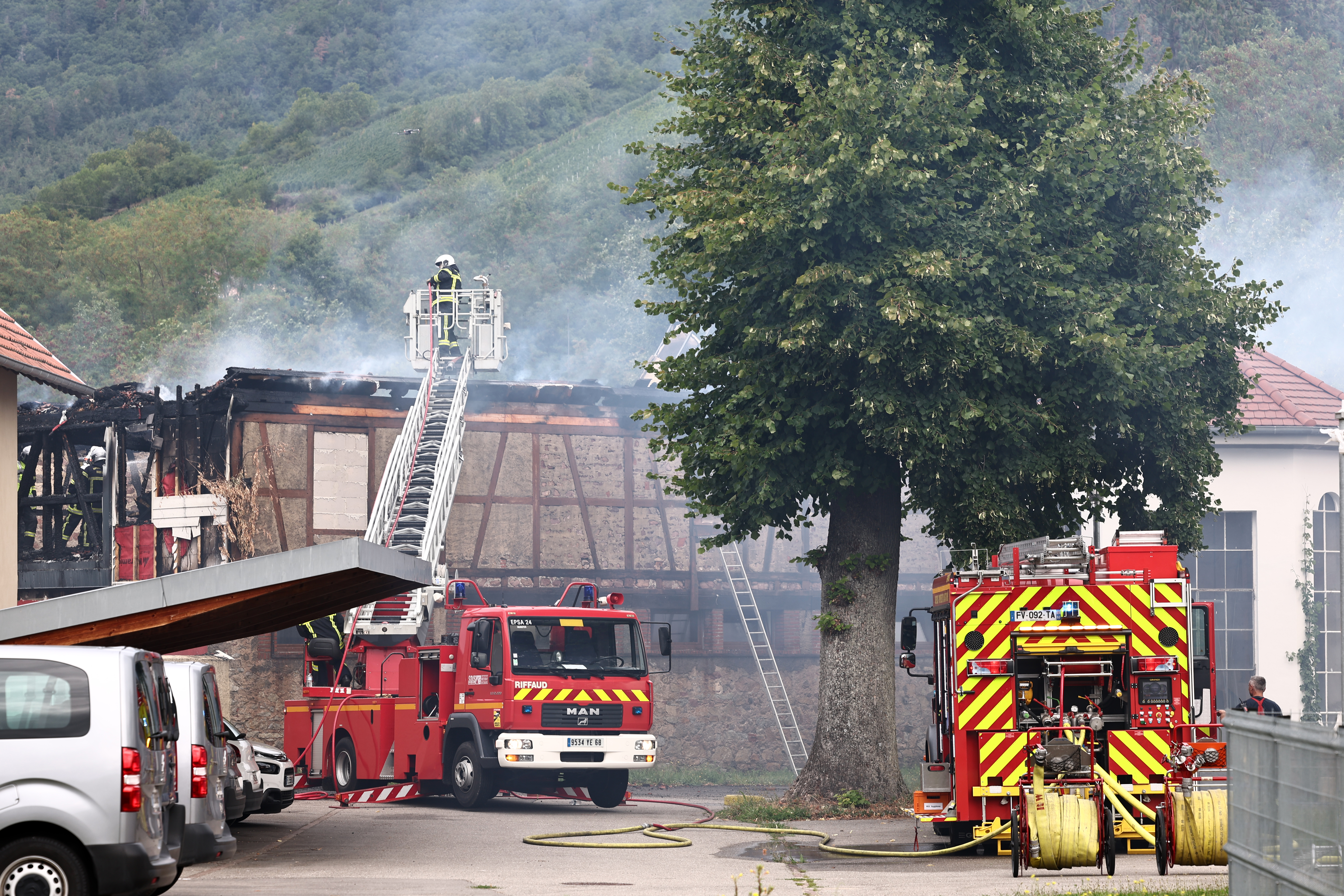 Firefighters work to extinguish a fire which erupted at a home for disabled people in Wintzenheim near Colmar, eastern France