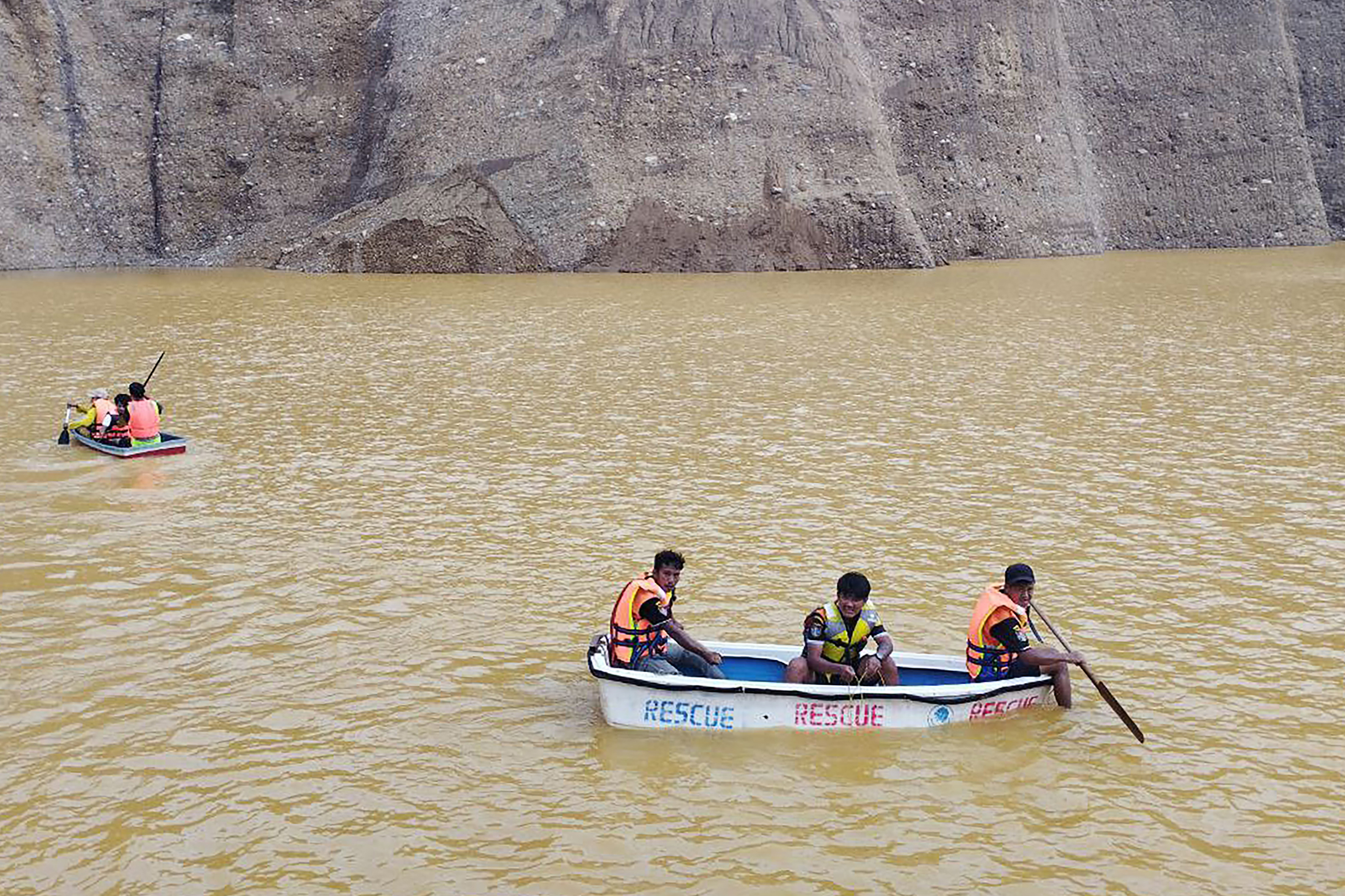 Rescue workers seen at the site of a deadly landslide in Myanmar