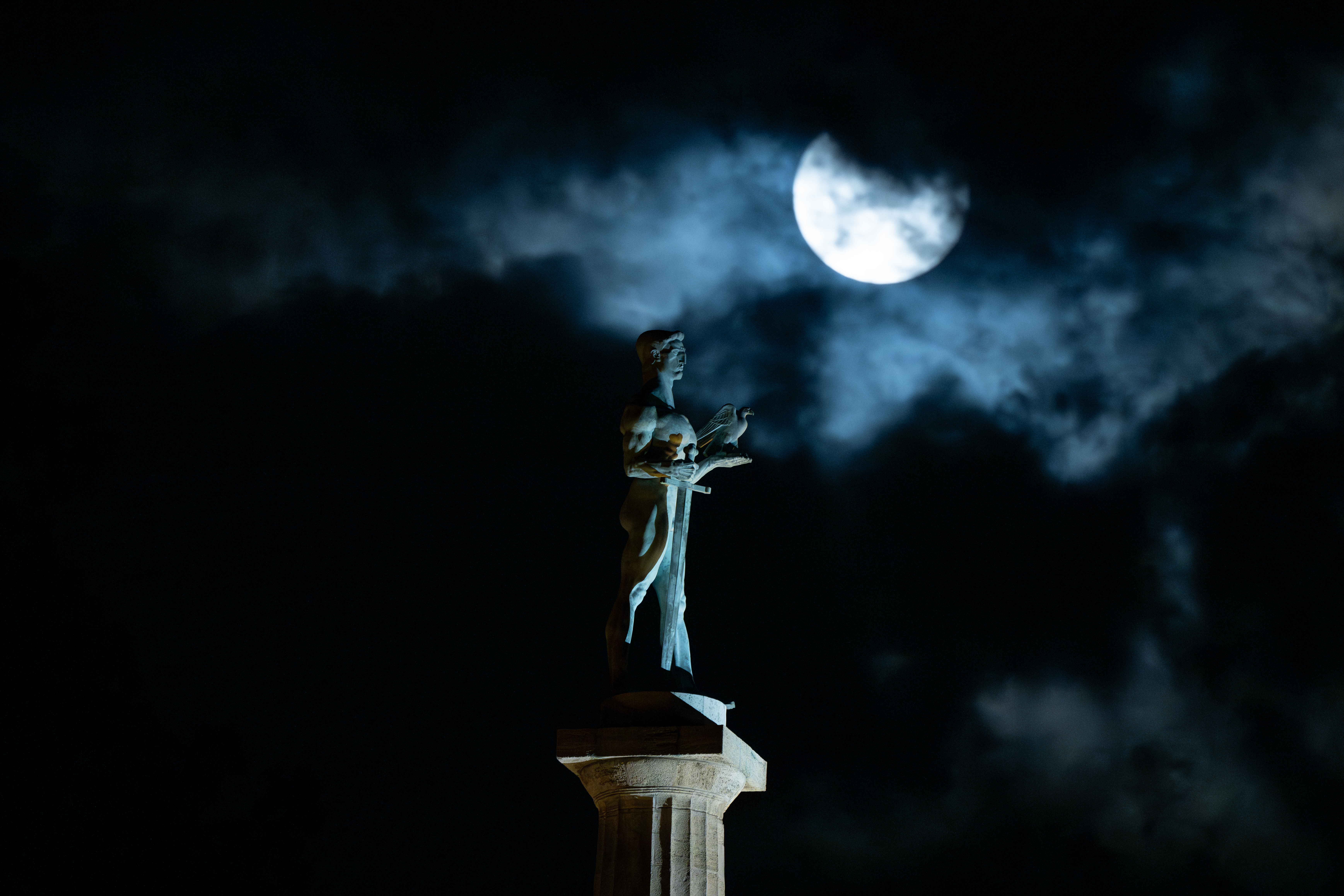 The "Blue Supermoon", the second full moon of a calendar month, rises behind the landmark monument 'The Victor'