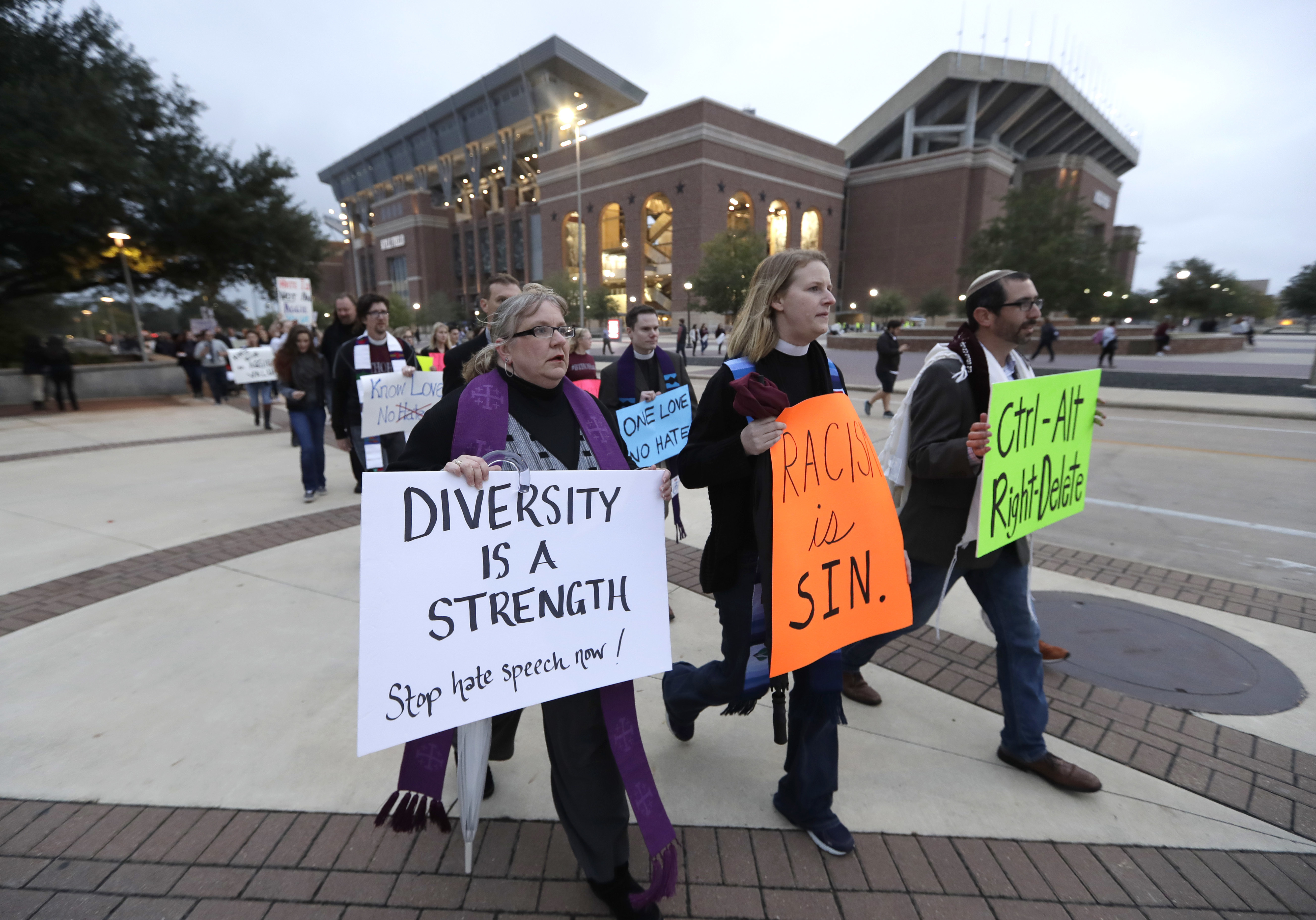 Demonstrators walks past Kyle Field toward the venue where Richard Spencer, who leads a movement that mixes racism, white nationalism and populism, is scheduled to speak at Texas A&amp;M University, Tuesday, Dec. 6, 2016, in College Station, Texas. Spencer is scheduled to speak at Texas A&amp;M University after being invited by a former student. The university is holding a an event to highlight diversity and unity at the same time Spencer is set to speak. (AP Photo/David J. Phillip)