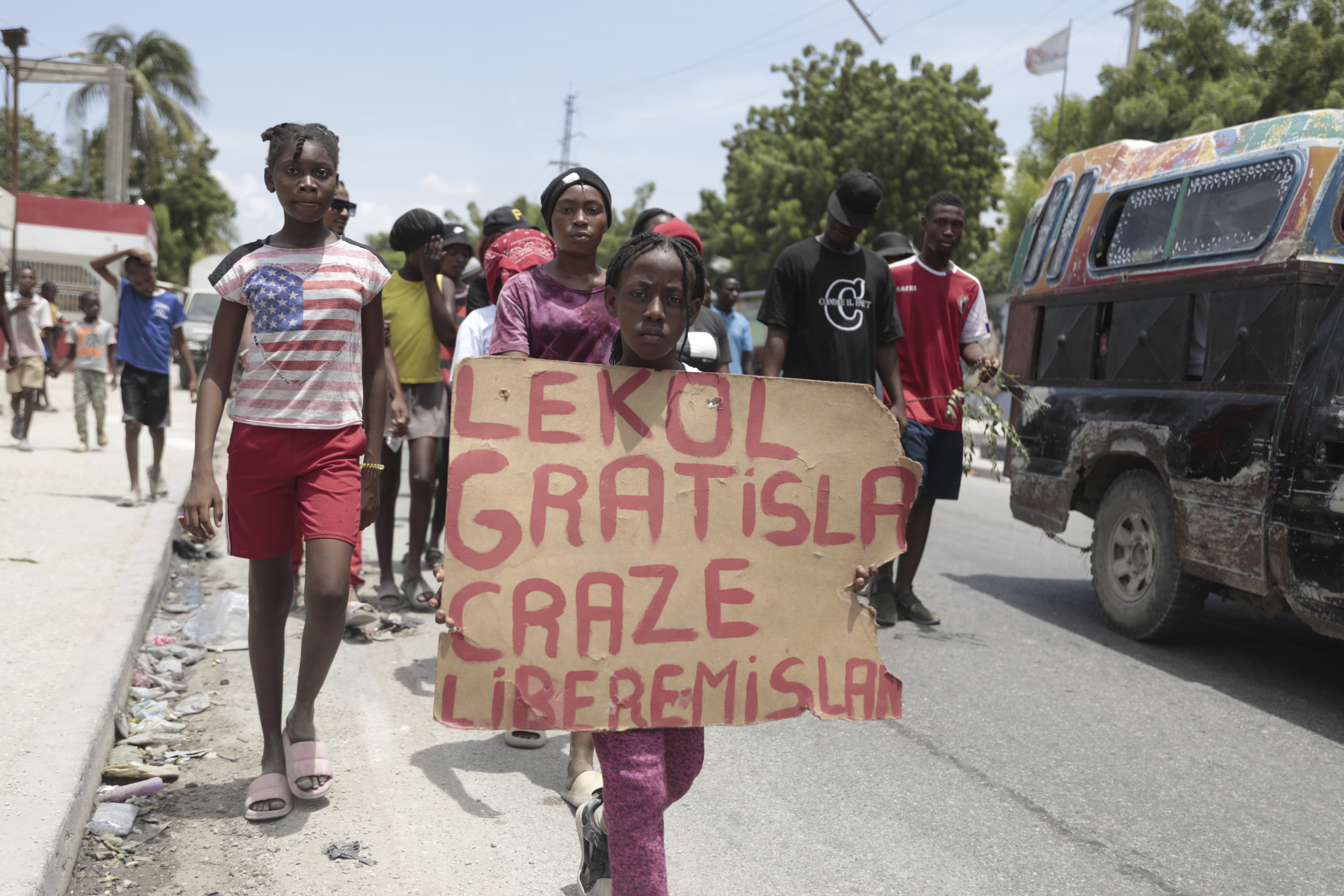 A girl holds a sign during a protest in Haiti demanding the release of a US nurse who was reported kidnapped