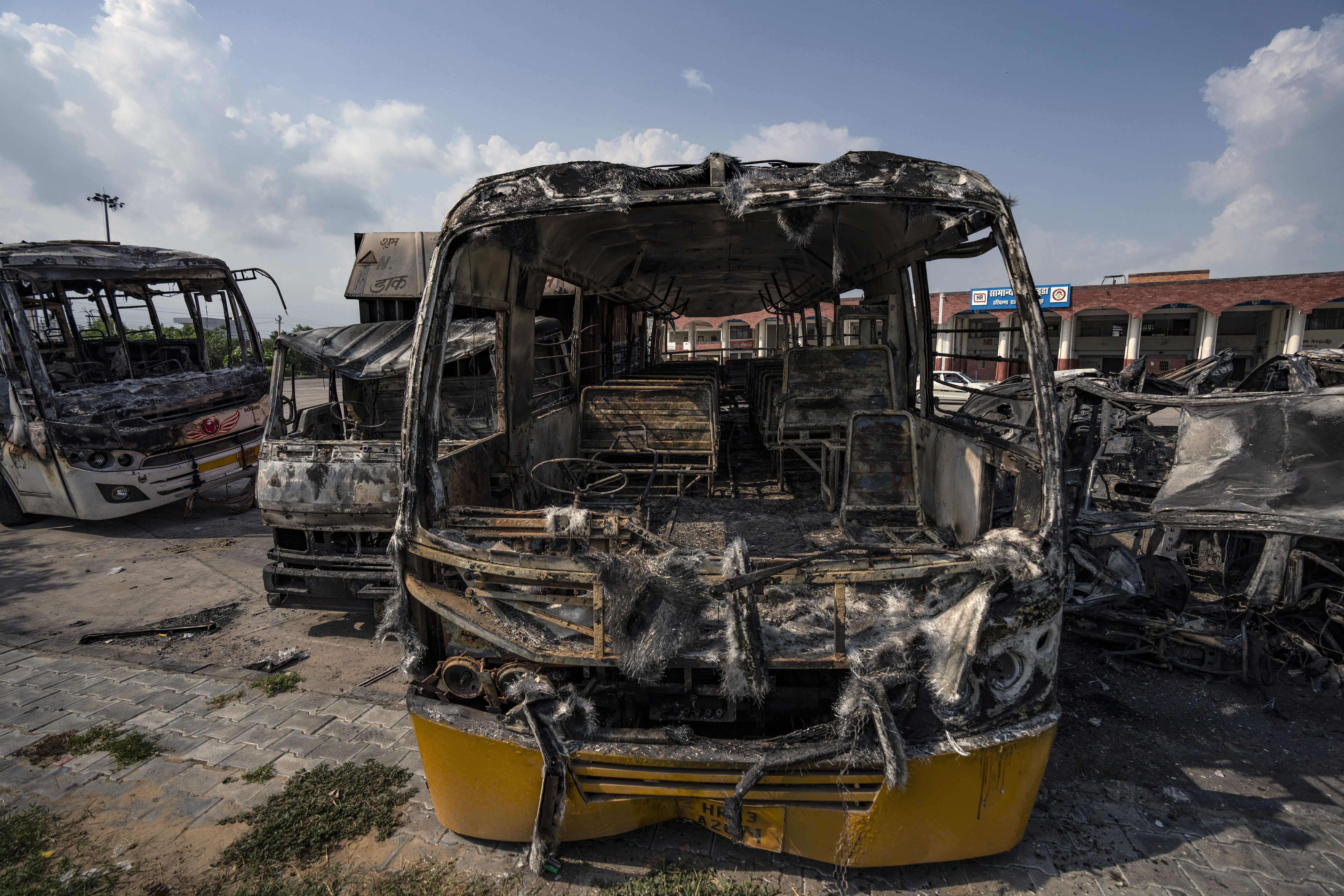 Burnt vehicles stand in a transport yard in Nuh in Haryana state, India