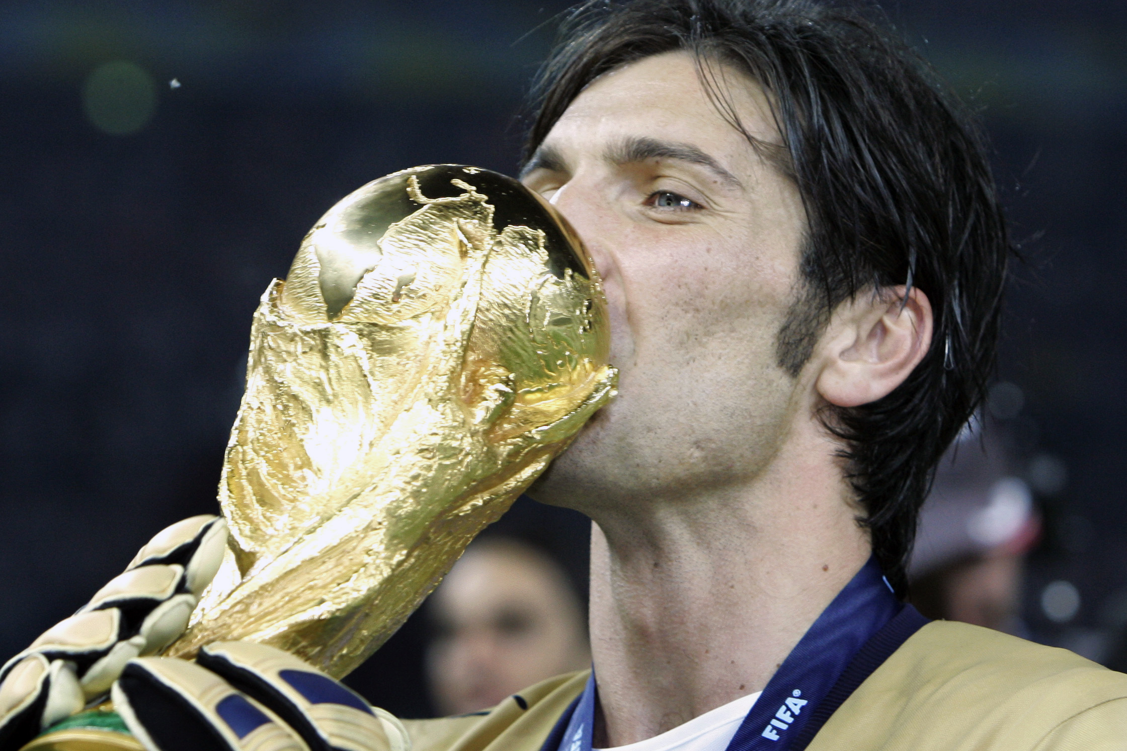 Italy's goalkeeper Gianluigi Buffon kisses the World Cup trophy