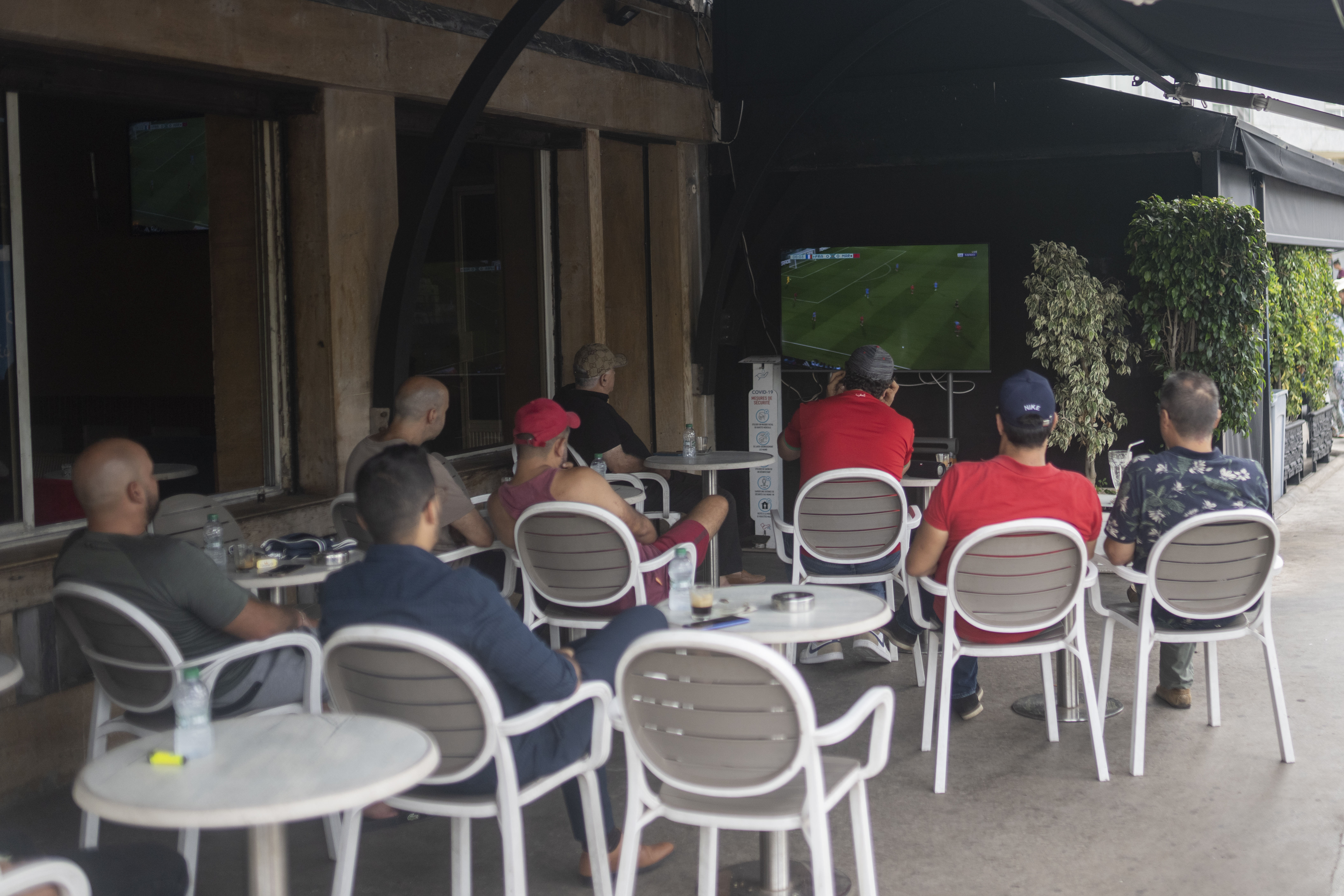 Moroccan men watch a soccer game in a coffee shop between Morocco and France