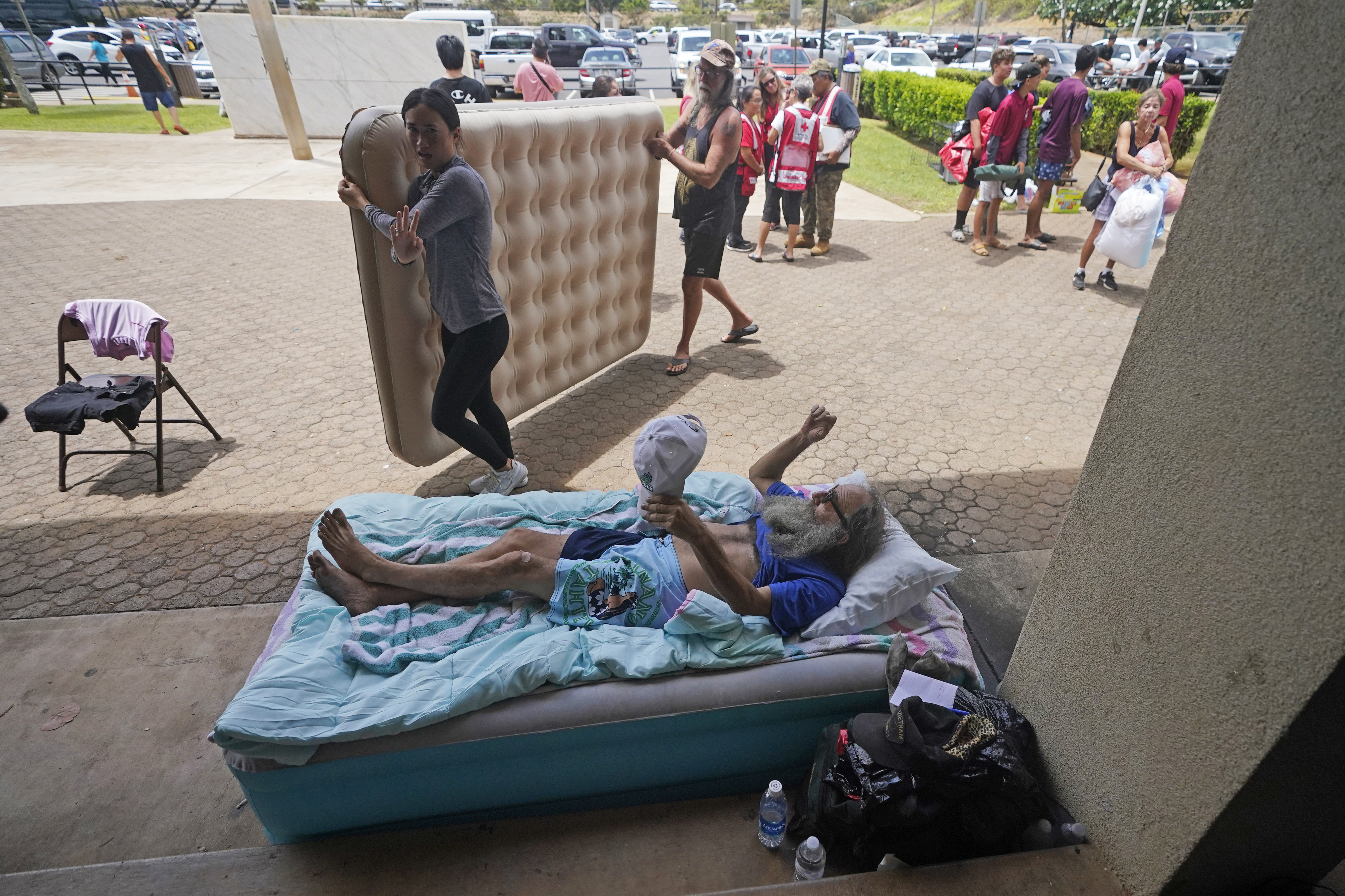 Hawaii resident Thomas Leonard lies on an air mattress at an evacuation centre after wildfires destroyed the town of Lahaina