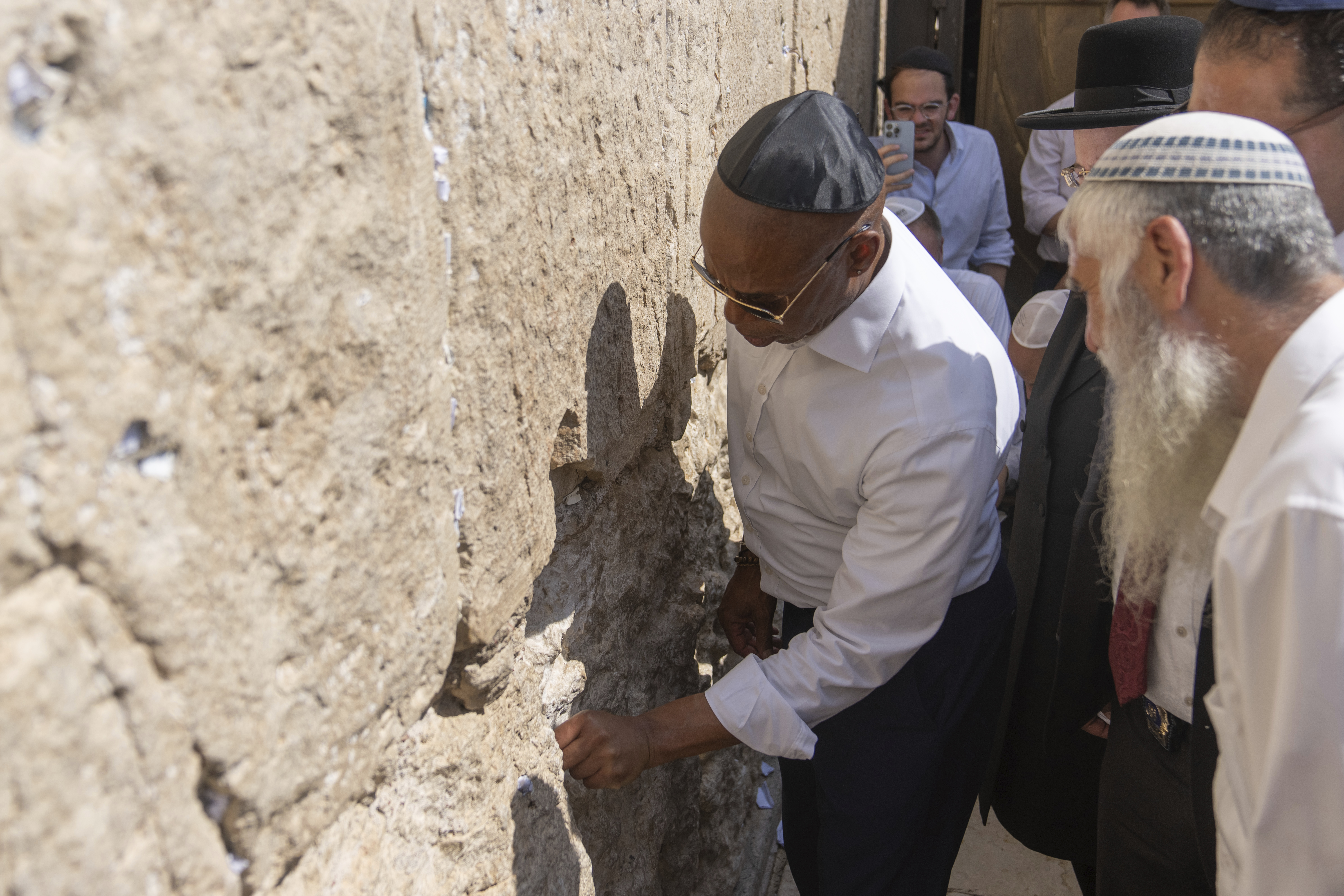 Eric Adams is seen touching the Western Wall in Jerusalem.