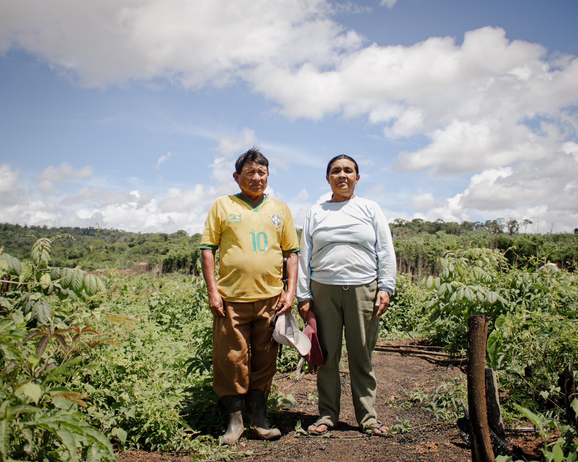 Telma Macuxi and her husband pose in front of their field in Brazil