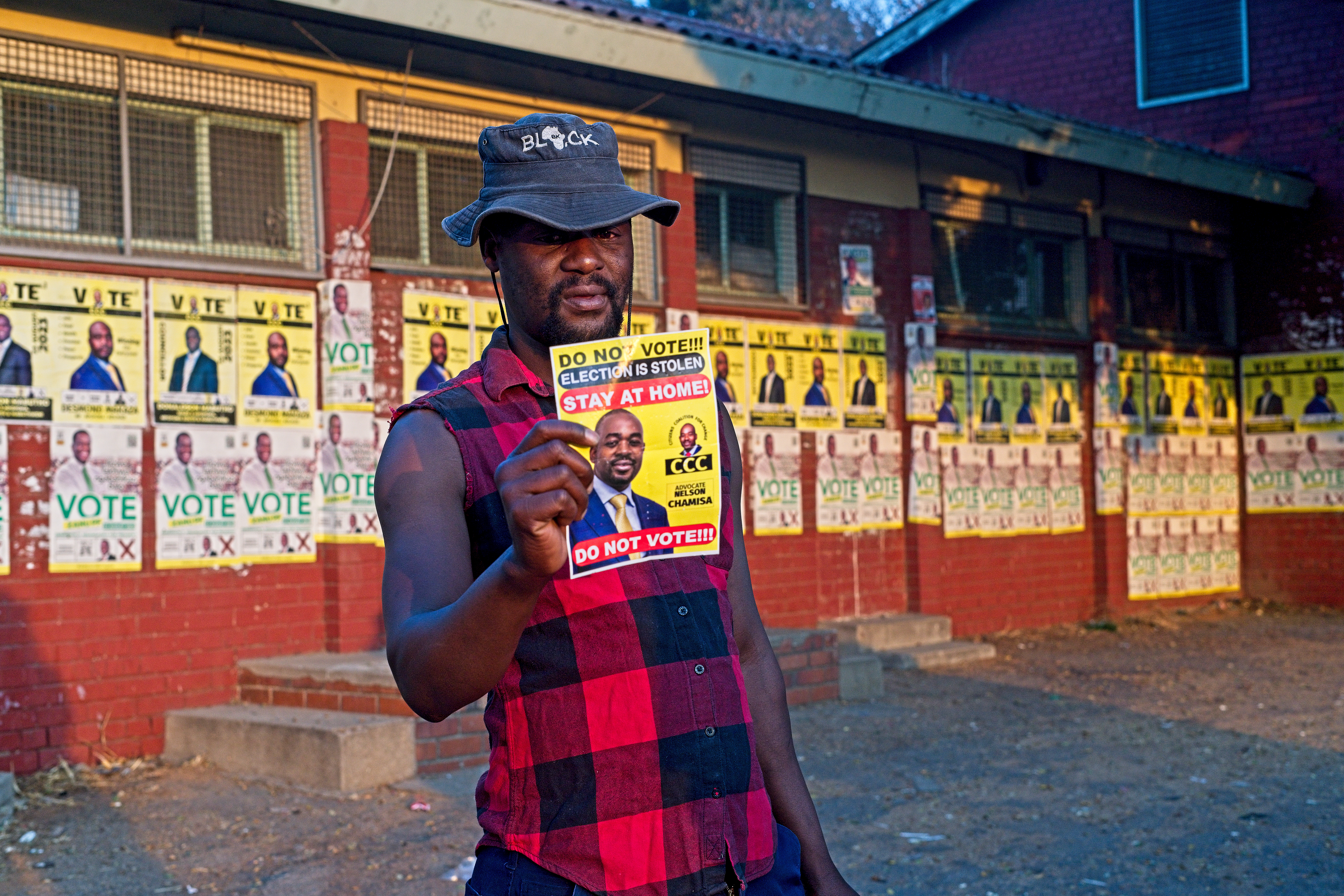Austin Maphosa, a security guard in Bulawayo, Zimbabwe, holds up one of many flyers thrown on the main streets of the city and which the Citizens Coalition for Change has distanced itself from 