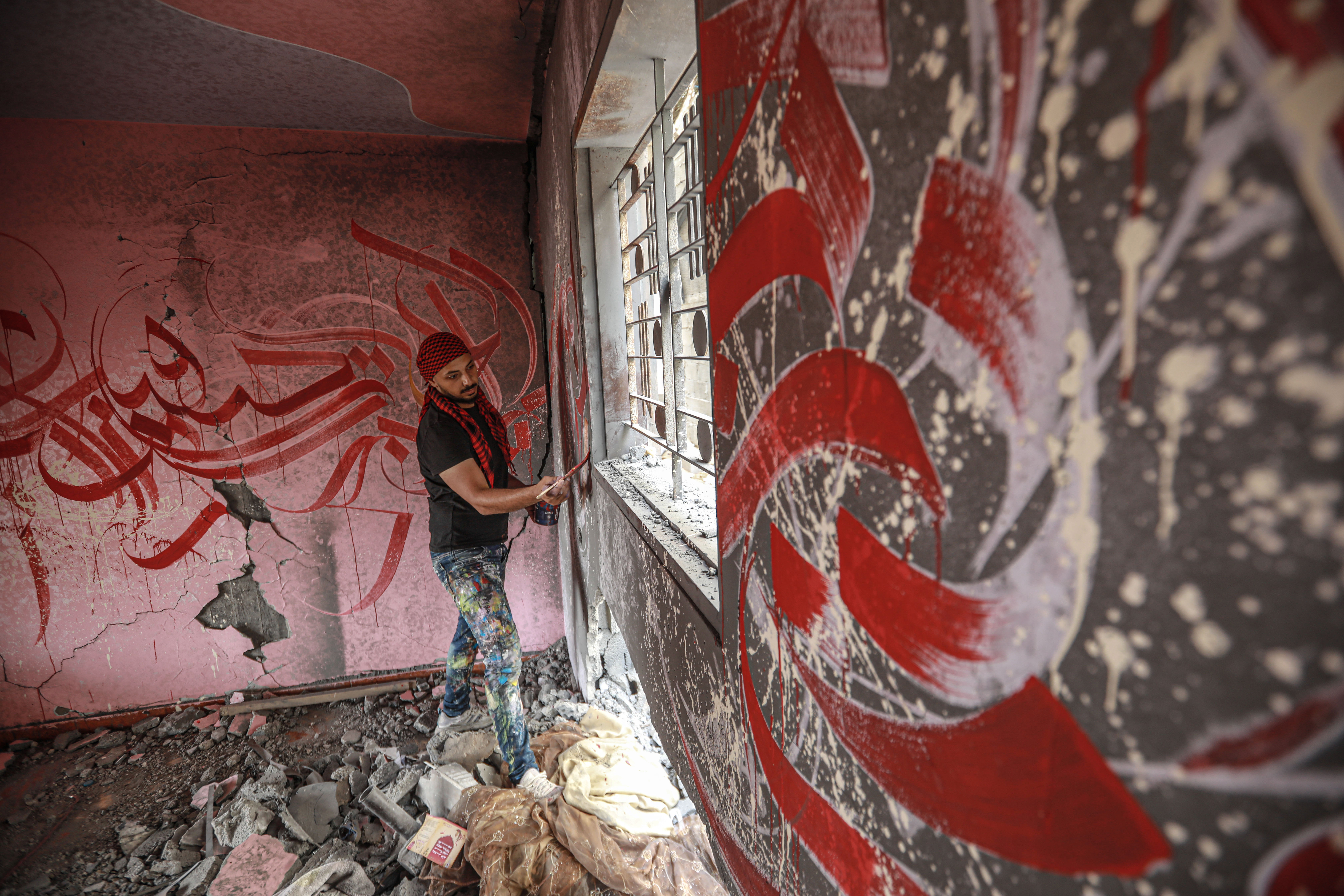 Ayman working in a destroyed house