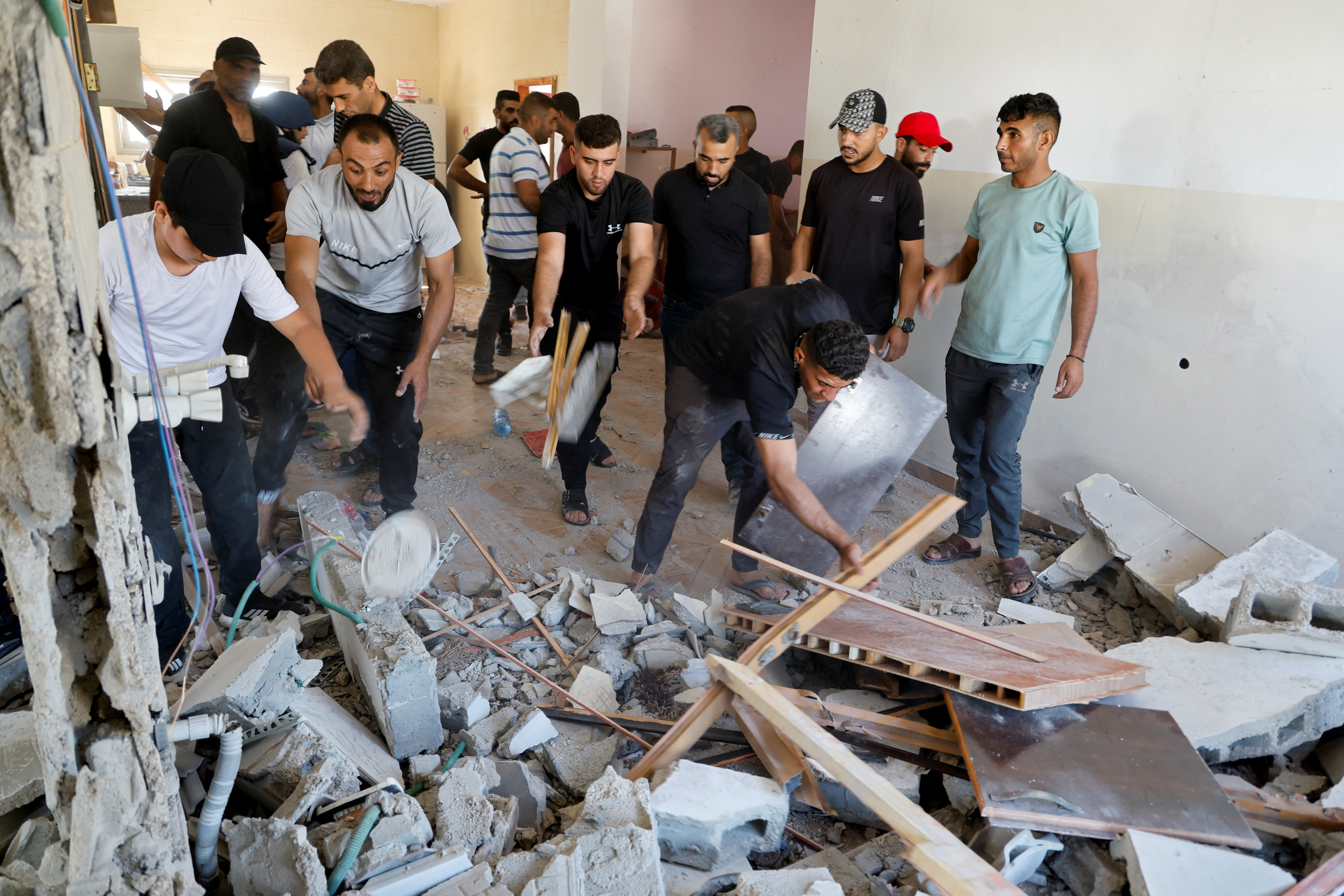 Palestinians inspect the house where a Palestinian militant was hiding which was destroyed by missiles during an Israeli raid near Tubas 