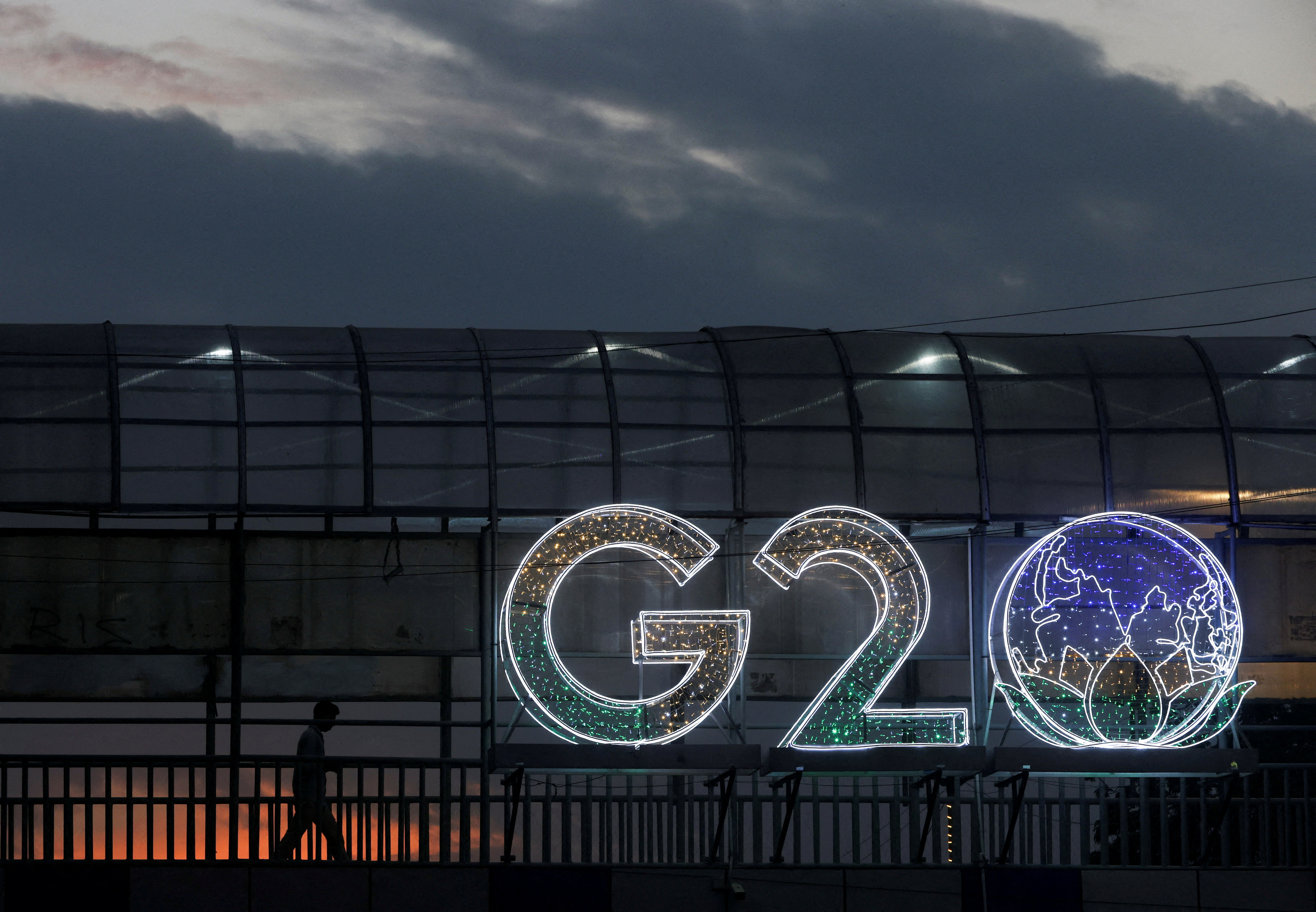 A man walks past an installation on a skywalk ahead of the G20 Summit in New Delhi, India, September 6, 2023