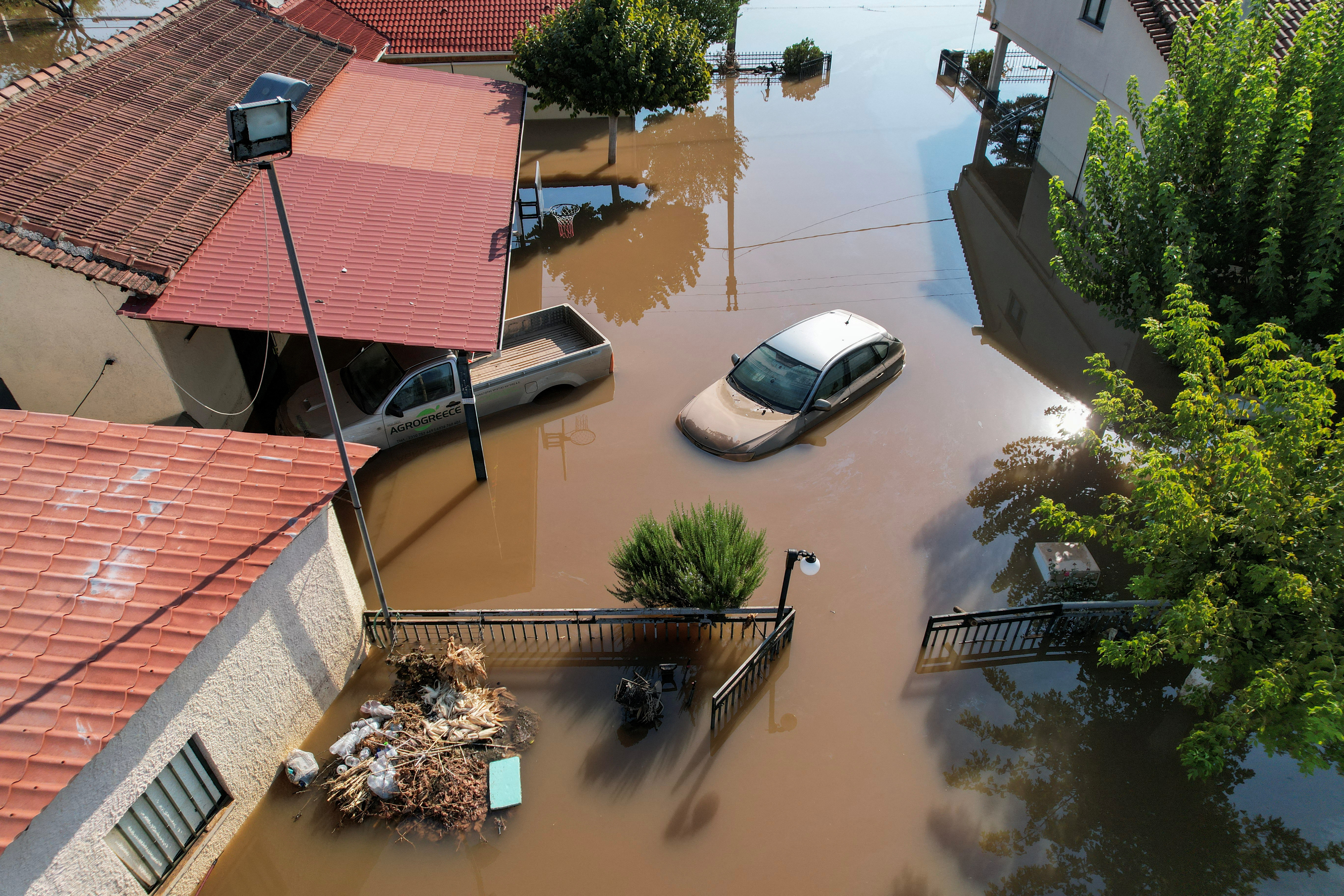 Cars are submerged in a flooded area