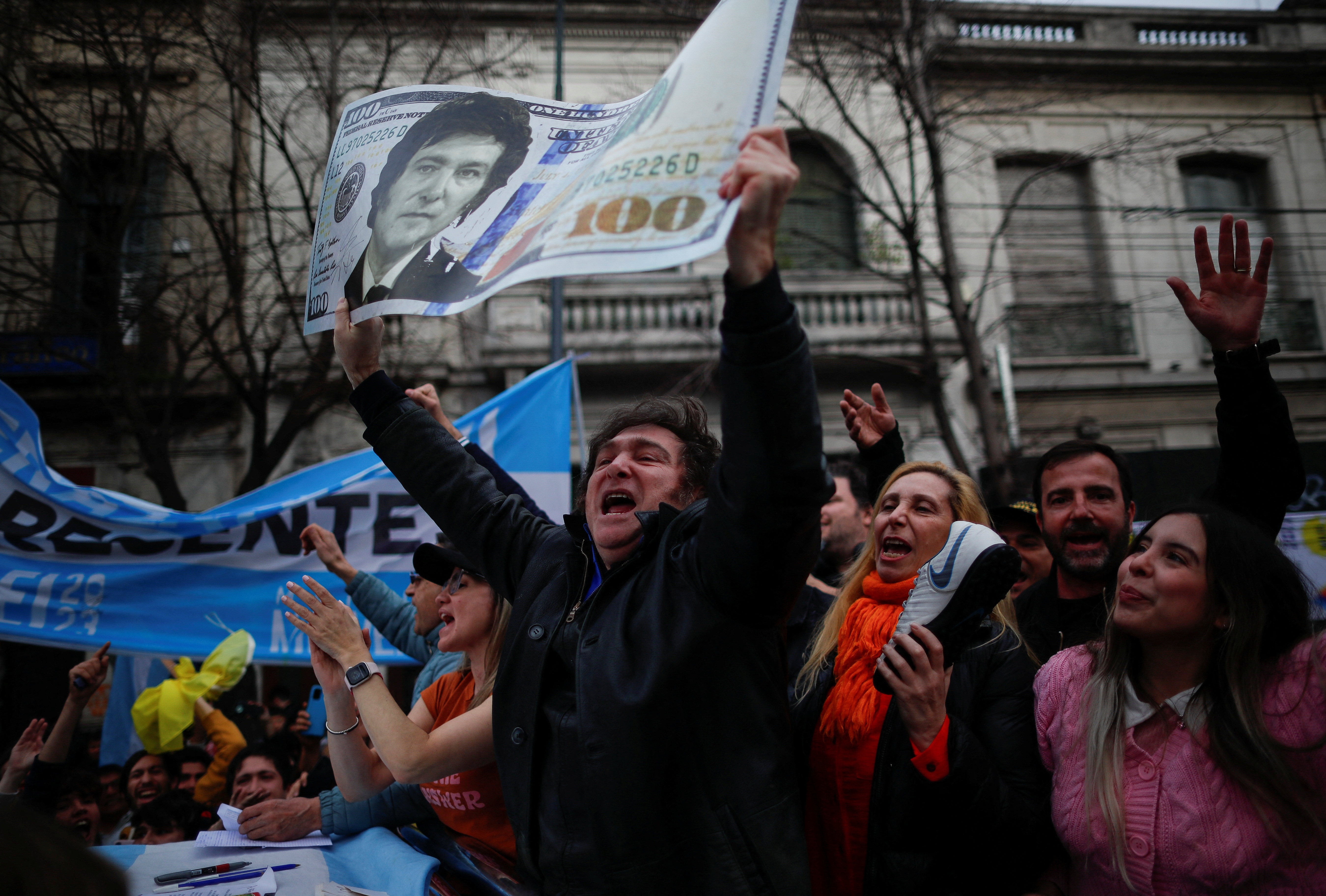 Argentine presidential candidate Javier Milei for La Libertad Avanza coalition holds a placard depicting a dollar bill with his face, during a campaign rally in La Plata, Buenos Aires, Argentina, September 12, 2023.