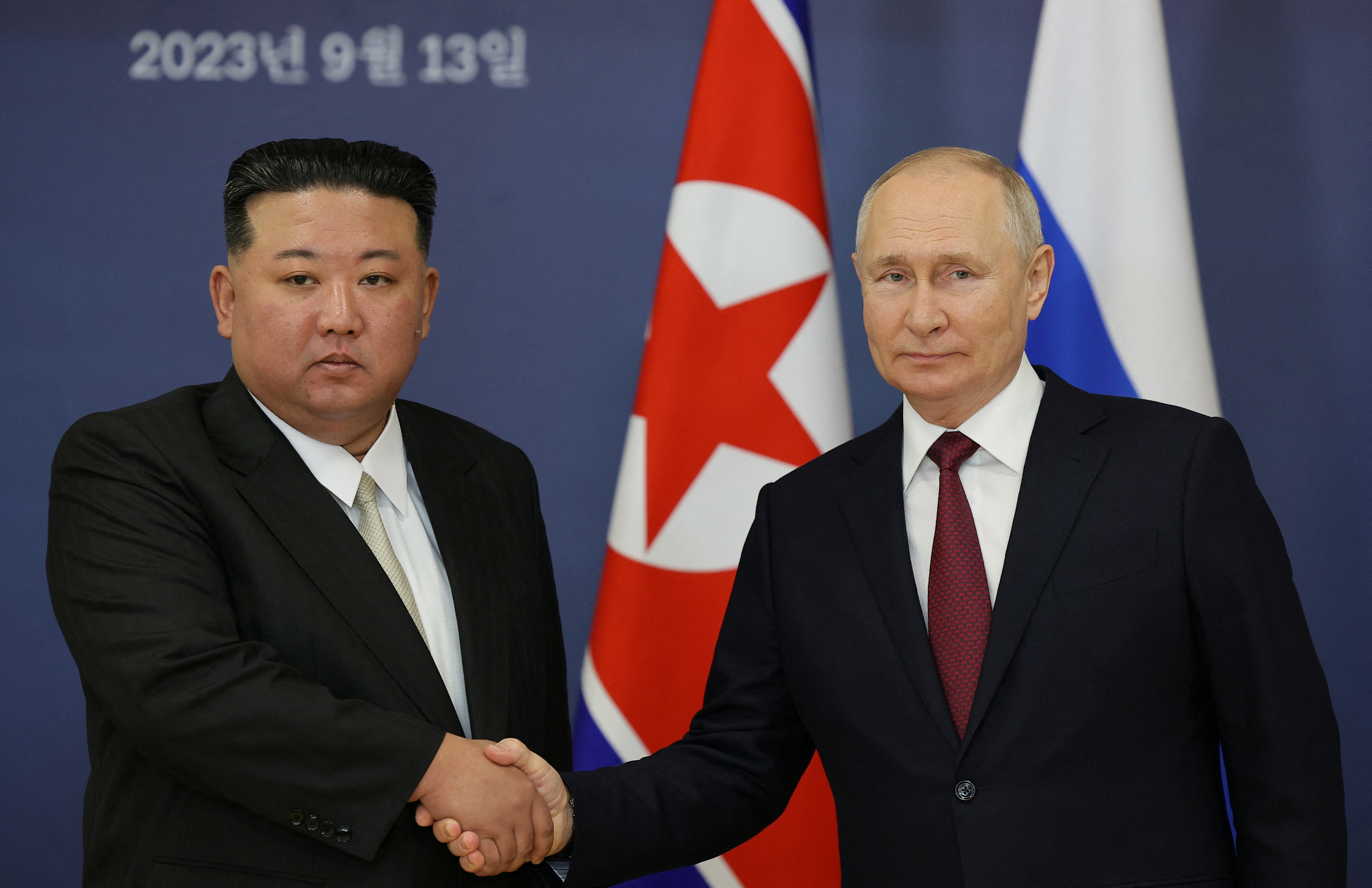 Russia's President Vladimir Putin shakes hands with North Korea's leader Kim Jong Un