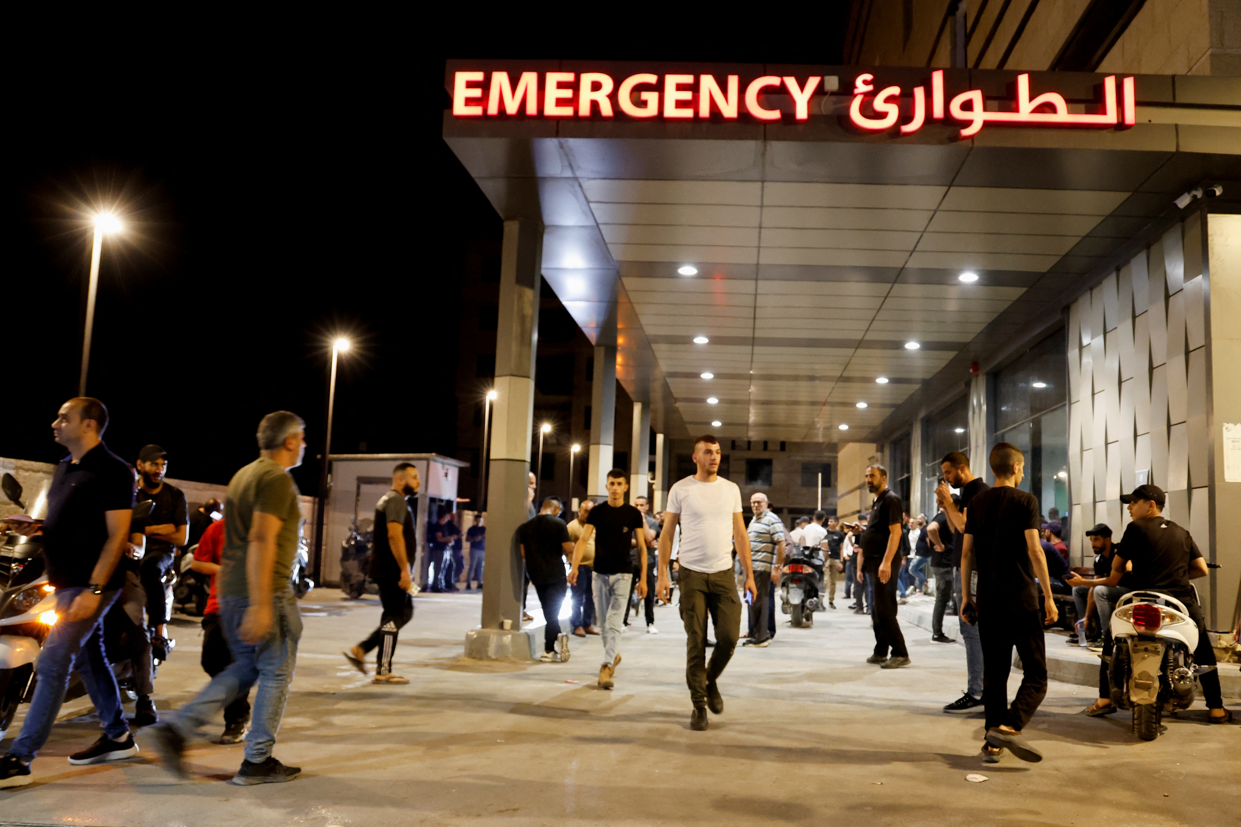 People stand outside a hospital, during an Israeli raid in Jenin, in the Israeli-occupied West Bank, September 19, 2023.