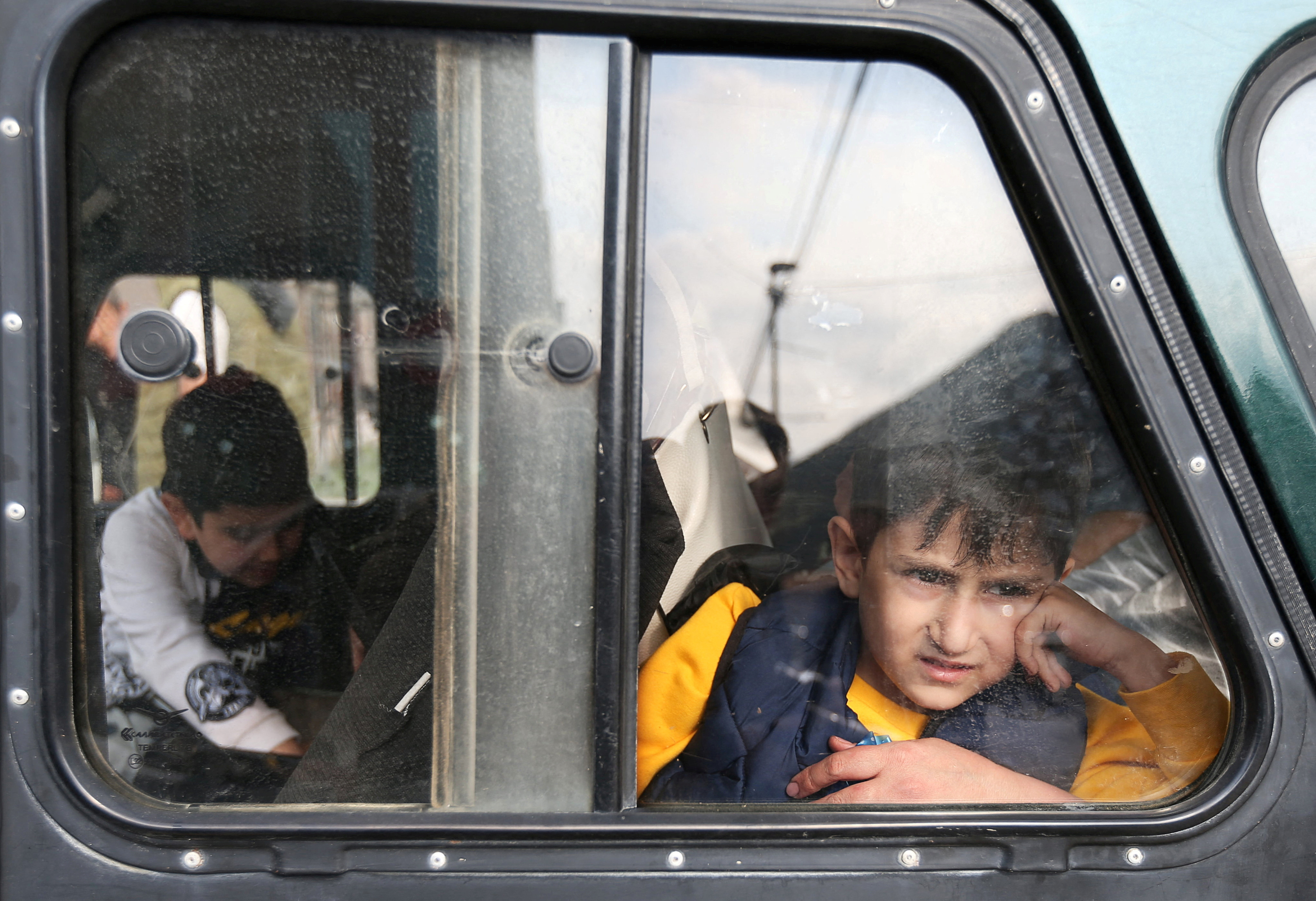 A refugee boy from Nagorno-Karabakh region looks out of a car window upon arrival at a temporary accommodation centre in the town of Goris, Armenia, September 25, 2023. REUTERS/Irakli Gedenidze TPX IMAGES OF THE DAY