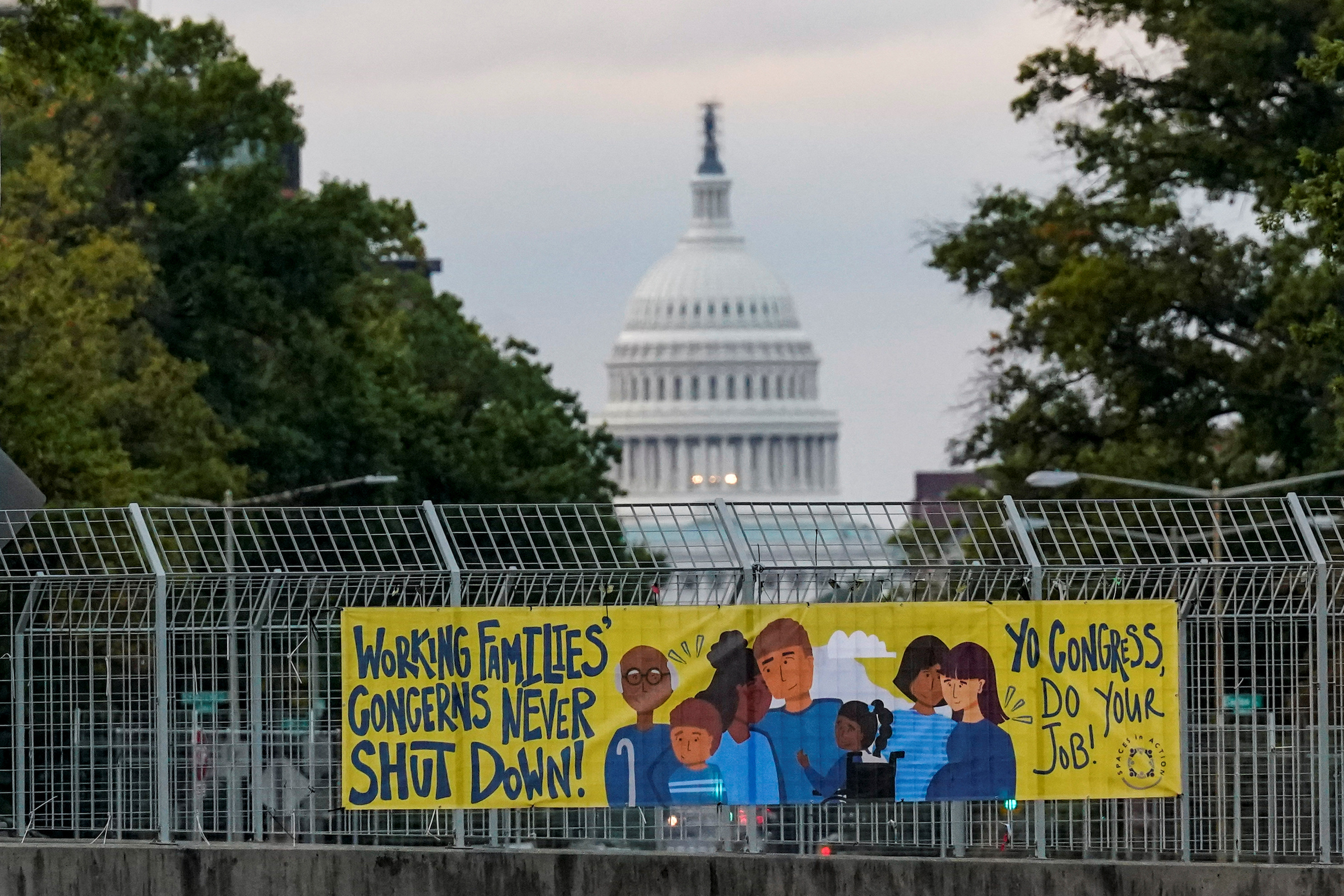 A view of a working families poster as the U.S. Capitol is seen in the background, as the deadline to avert a partial government shutdown approaches at the end of the day on Capitol Hill in Washington, U.S., September 30, 2023.