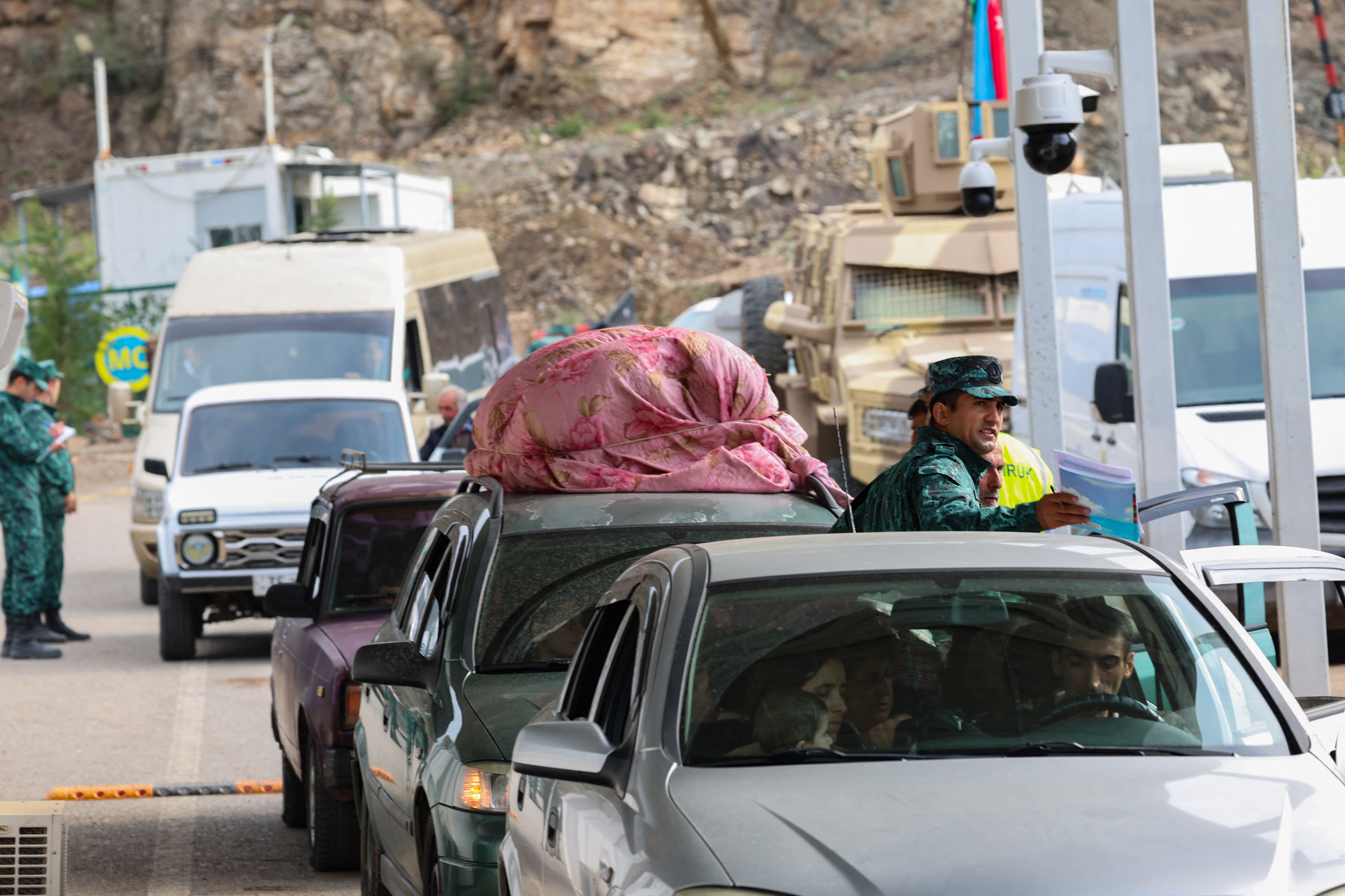 This photograph taken on September 26, 2023, at the Lachin checkpoint shows Armenian waiting in their cars at the border crossing station. - Hundreds of vehicles were heading towards Armenia from Nagorno-Karabakh on September 26, 2023, following the Azerbaijani army's lightning offensive in this separatist enclave, according to an AFP journalist (Photo by EMMANUEL DUNAND / AFP)