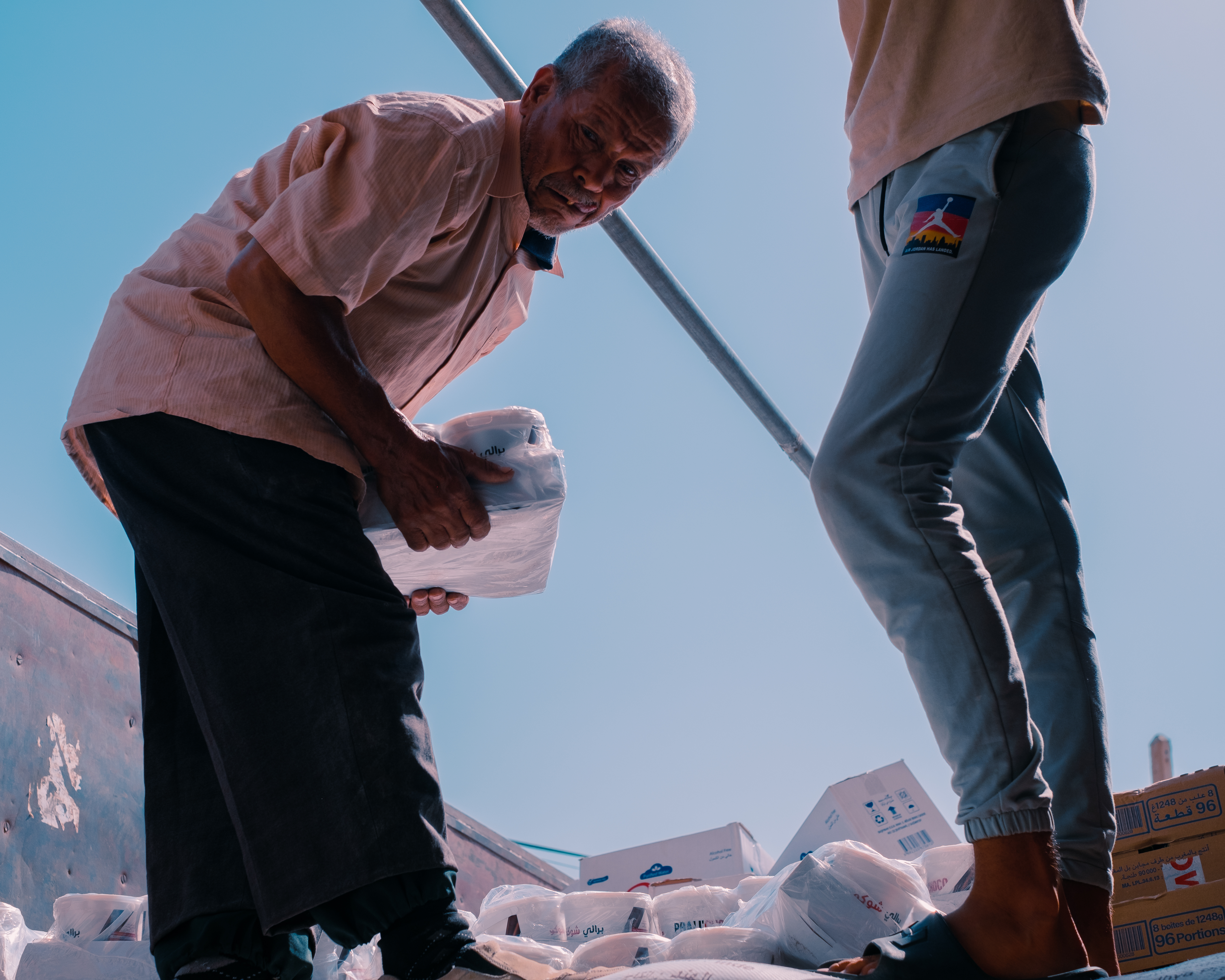 Rif Tribes Foundation volunteers distributing supplies in the village of Aït Si Allal [Bianca Carrera/Al Jazeera]