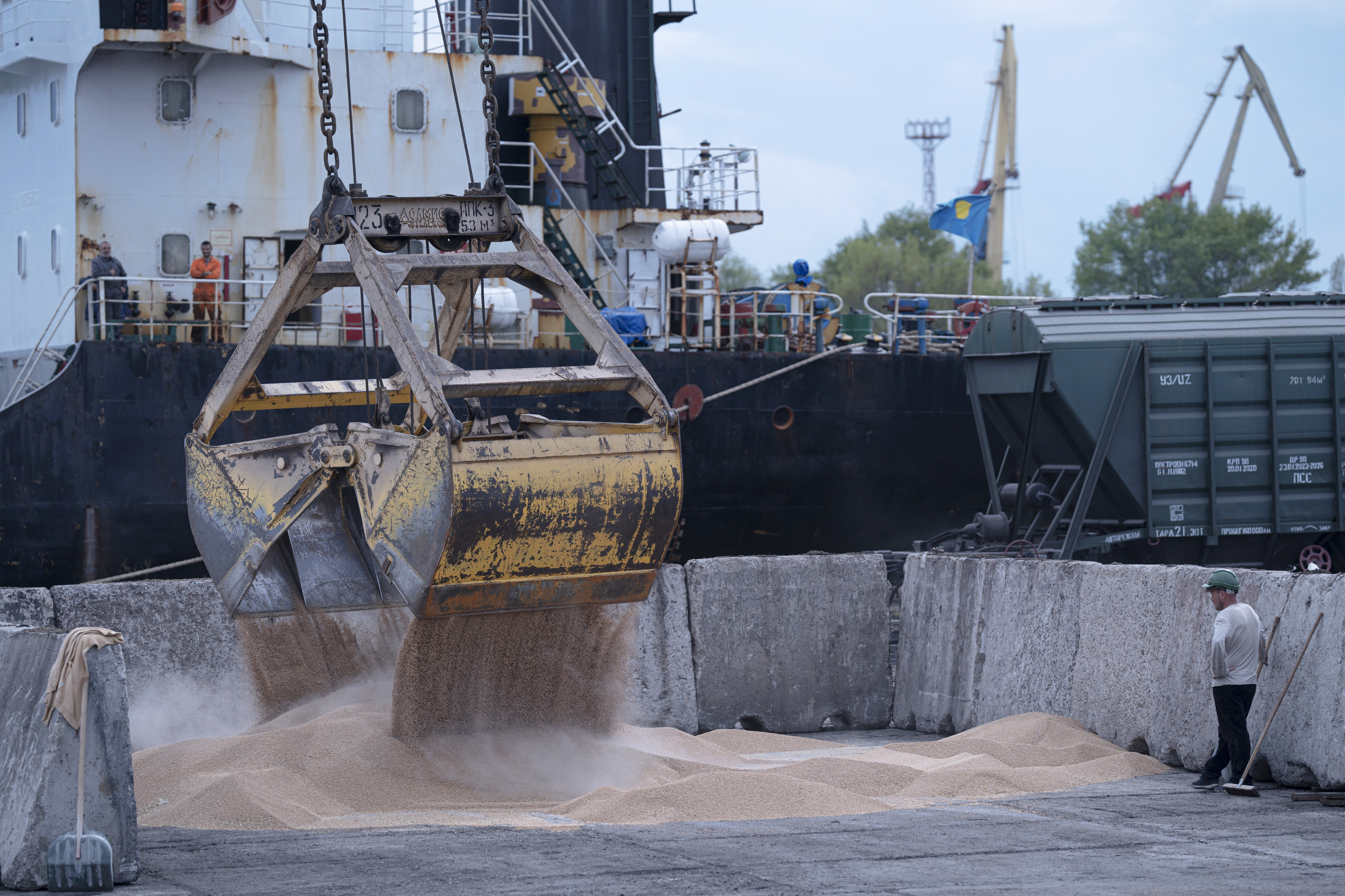Workers load grain at a grain port in Izmail, Ukraine, on April 26, 2023.