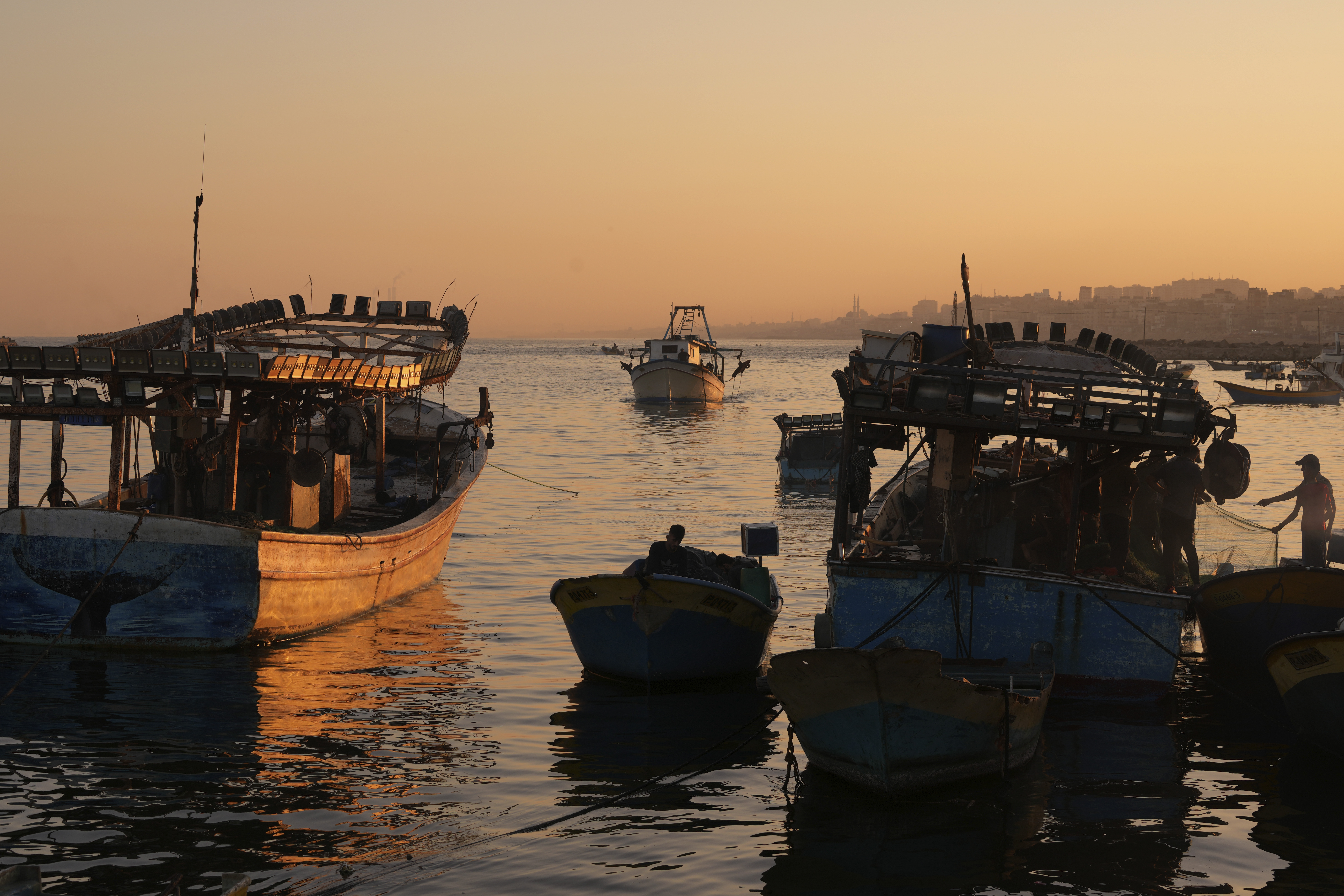 Palestinian fishing boats return after a nighttime fishing trip to the seaport in Gaza City, Thursday, Sept. 7, 2023