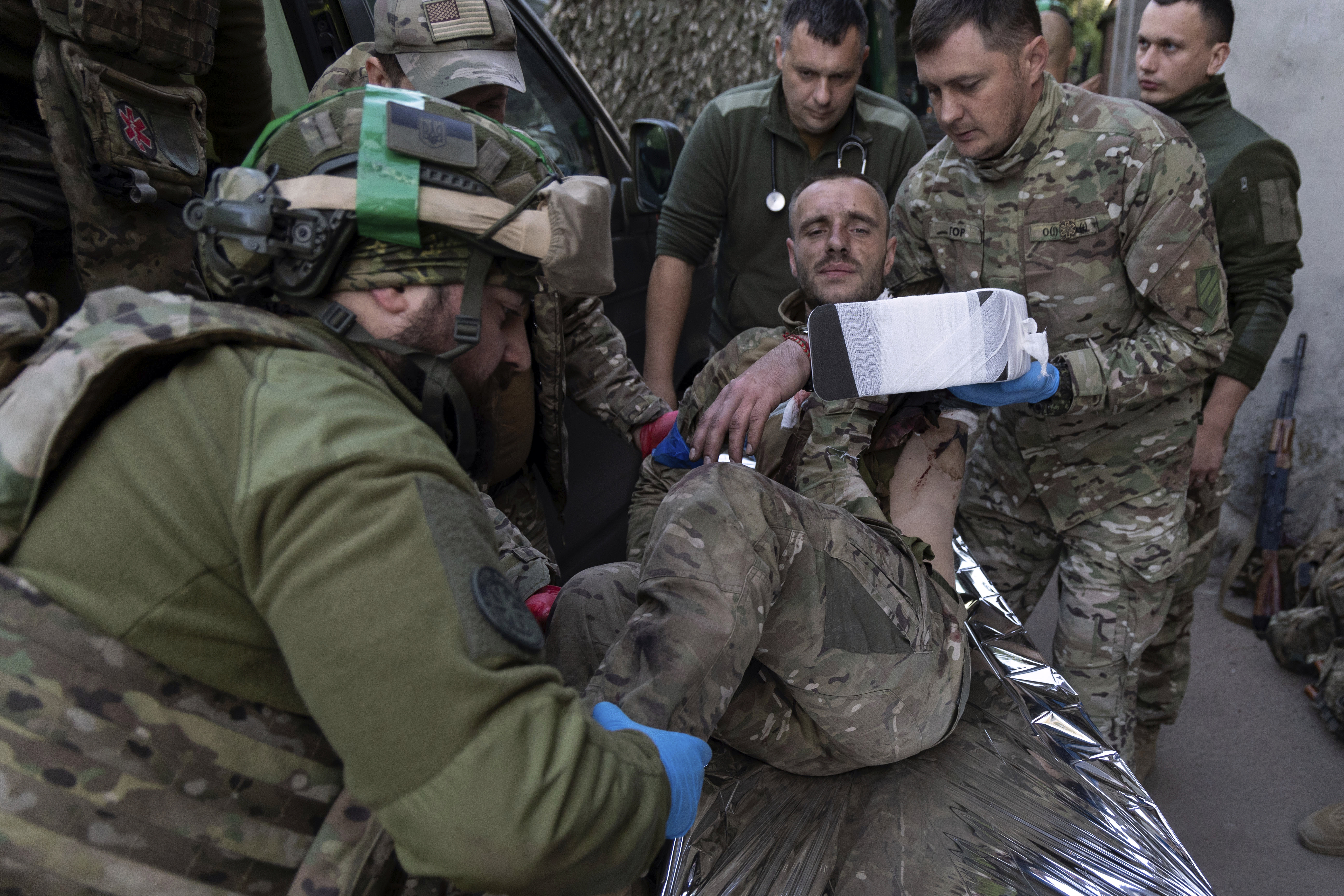 Ukrainian paramedics from 3rd Assault brigade move their wounded comrade on a stretcher arriving from the battlefield to the field hospital near Bakhmut, Donetsk region, Ukraine, Sunday, Sept. 10, 2023.